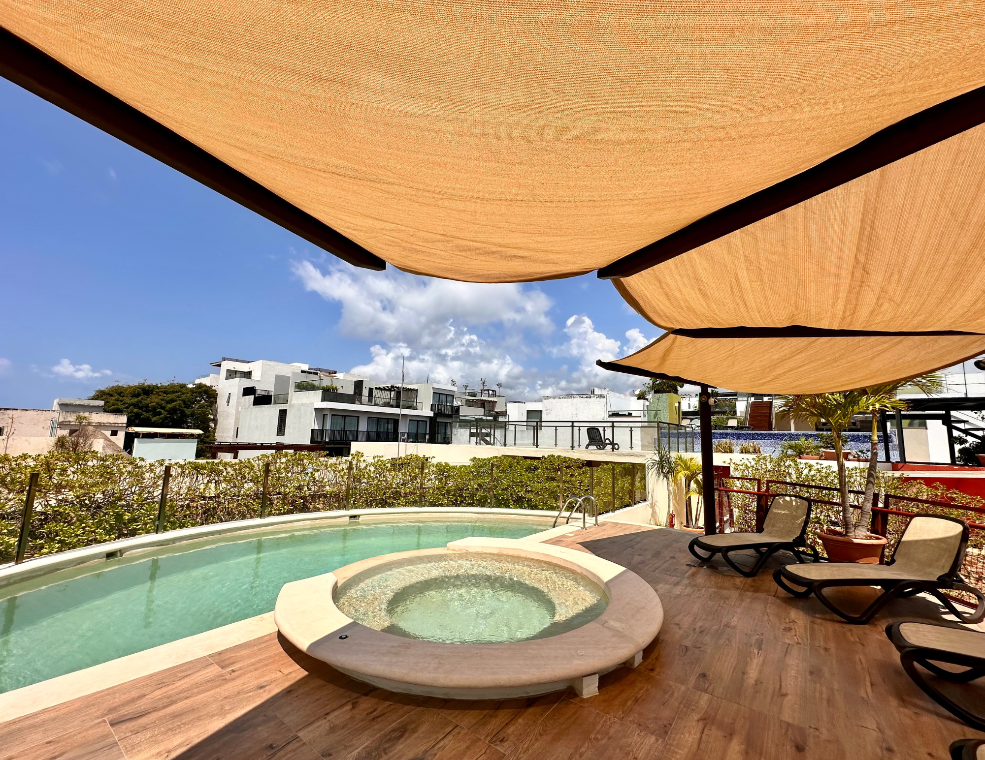 Rooftop pool and hot tub under canopy