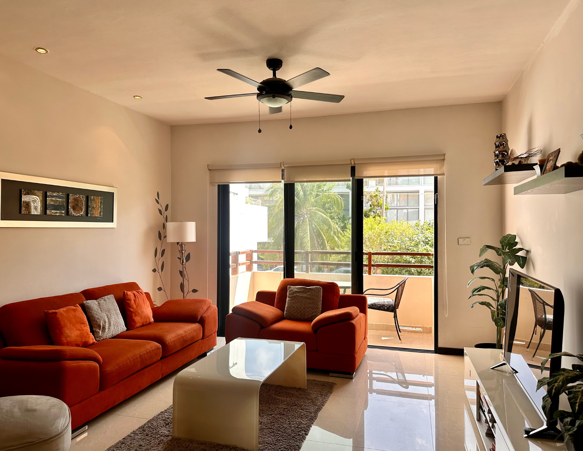 Modern living room with red sofas and balcony