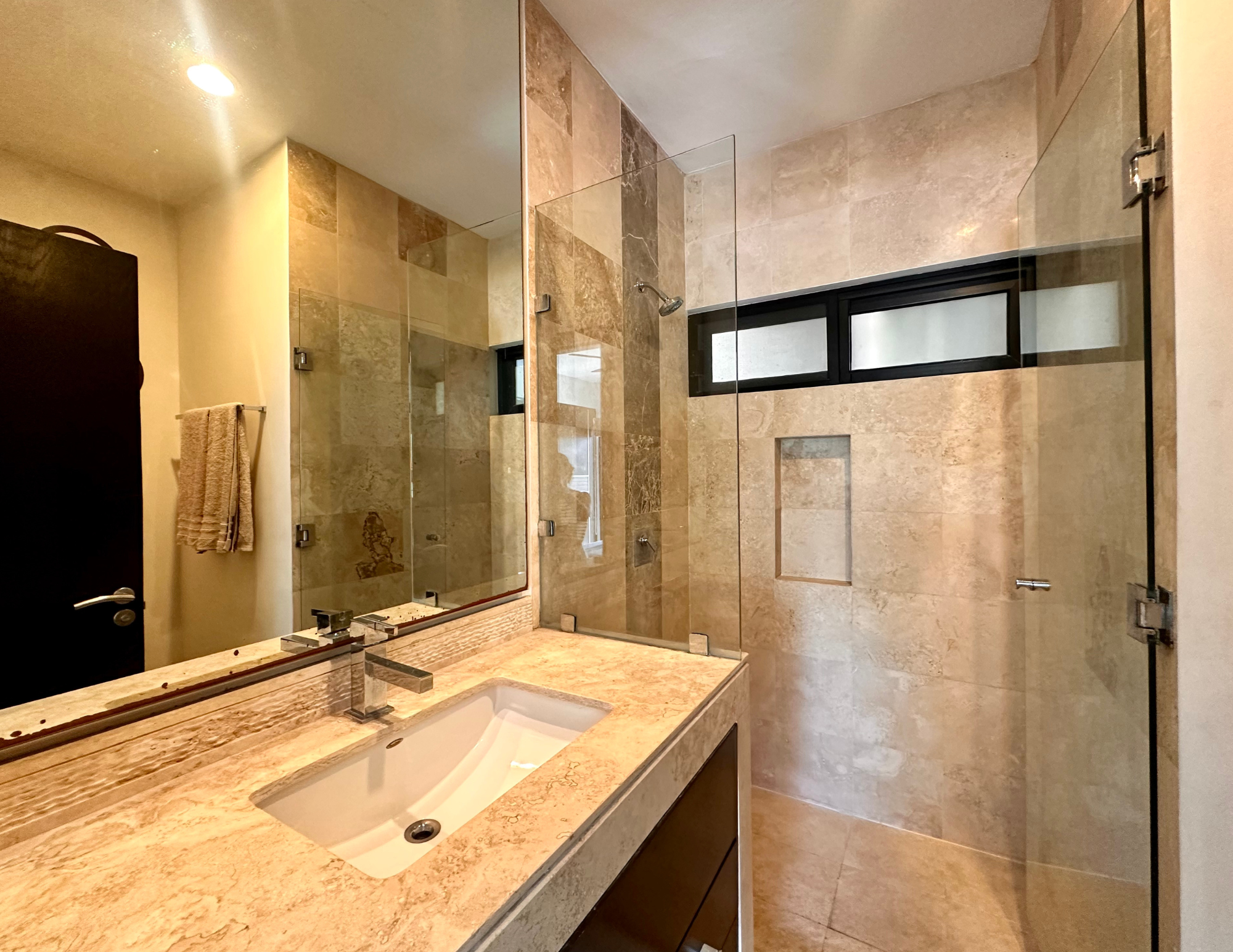 Modern marble countertop bathroom with glass shower