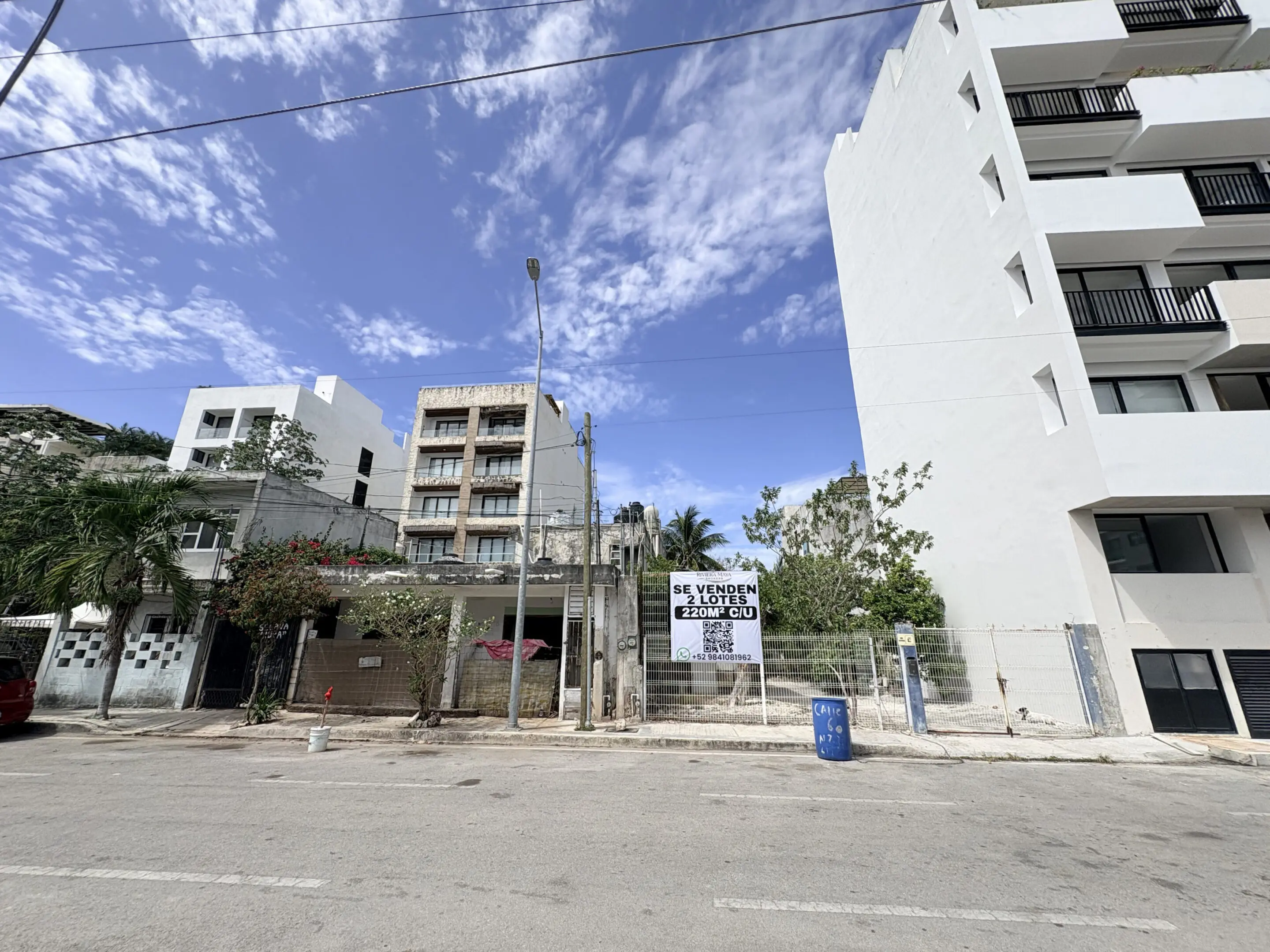 Urban street with vacant lot and buildings