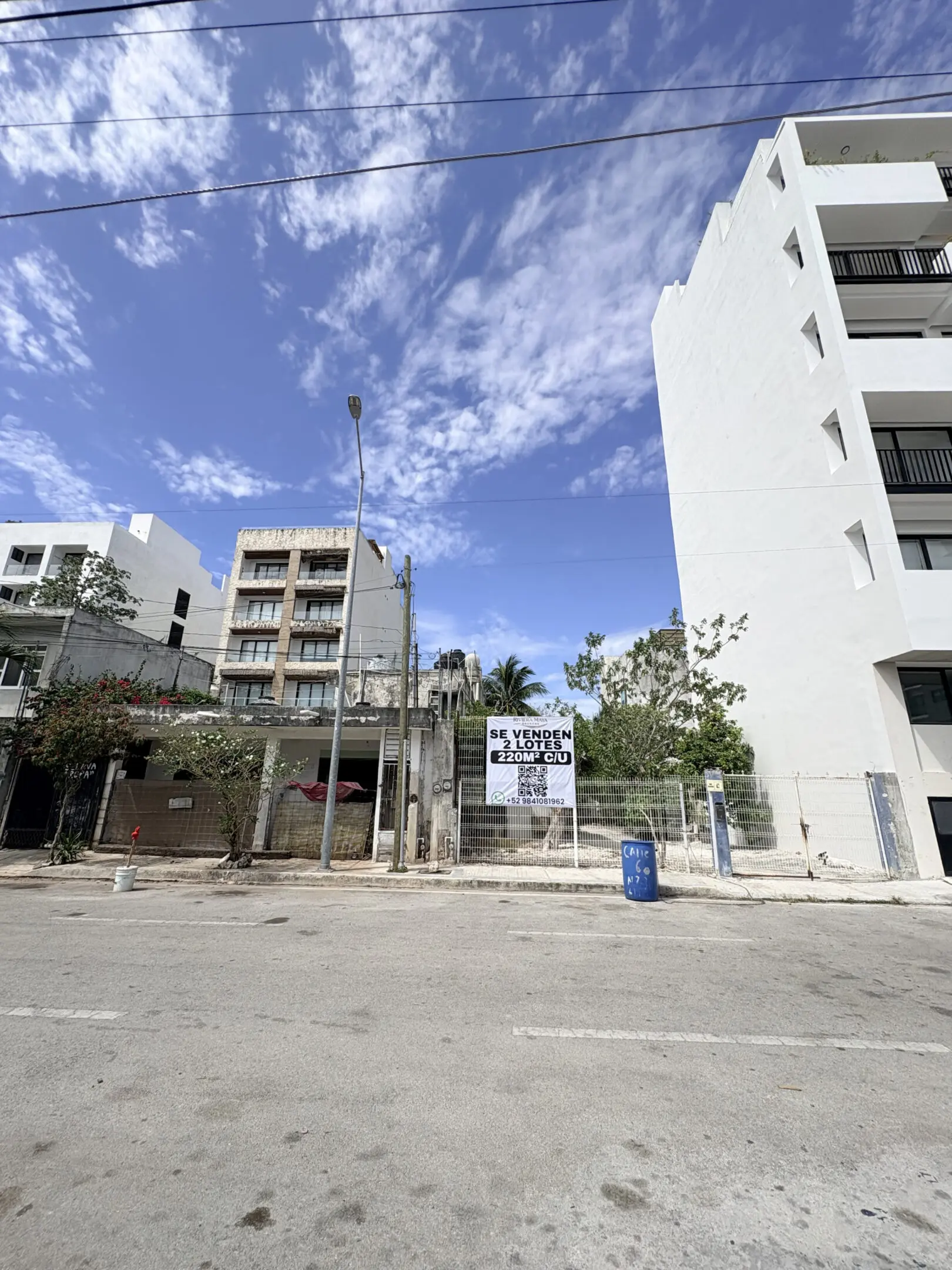 Urban street with vacant lot and buildings