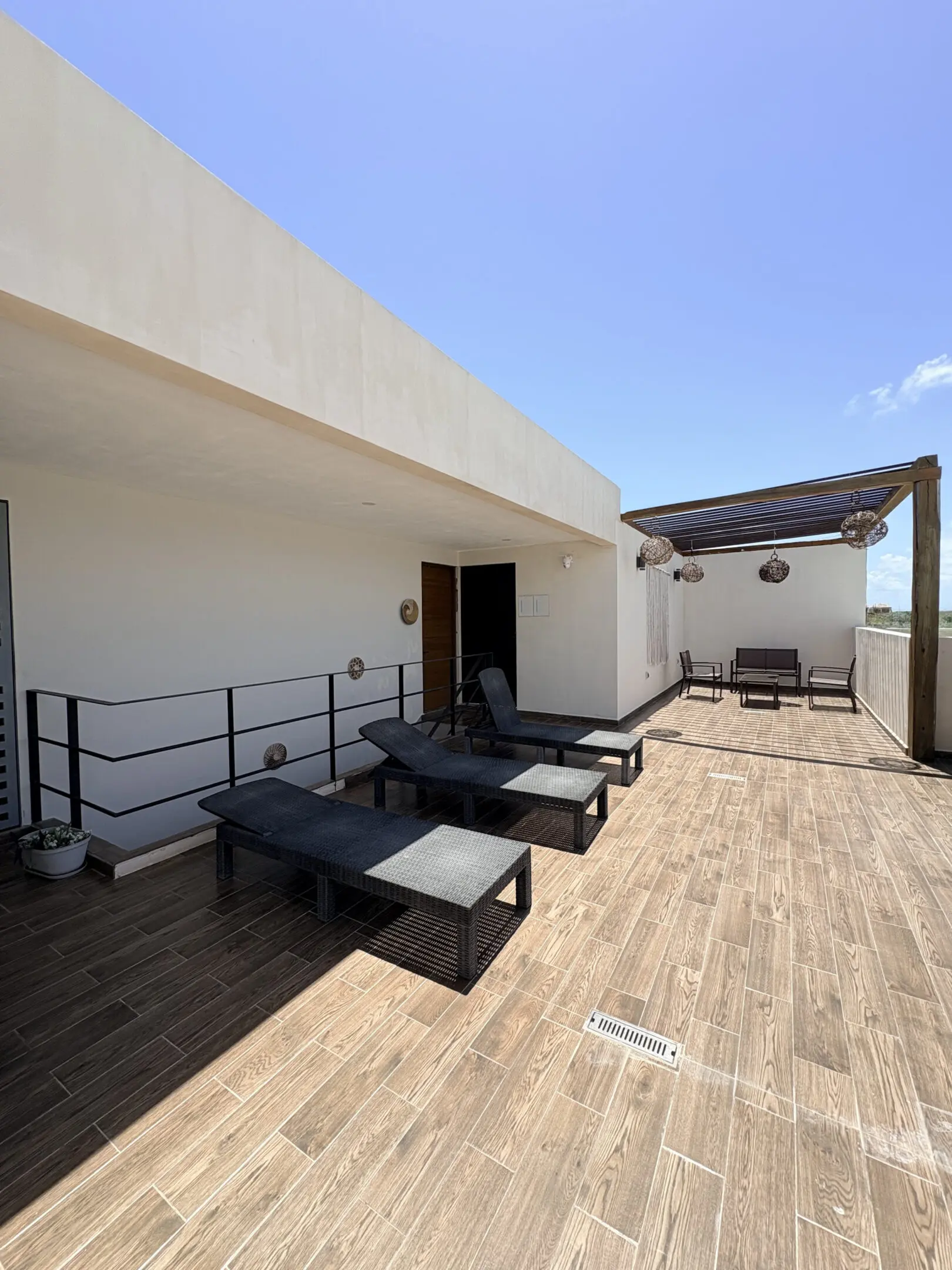 Rooftop terrace with lounge chairs and pergola