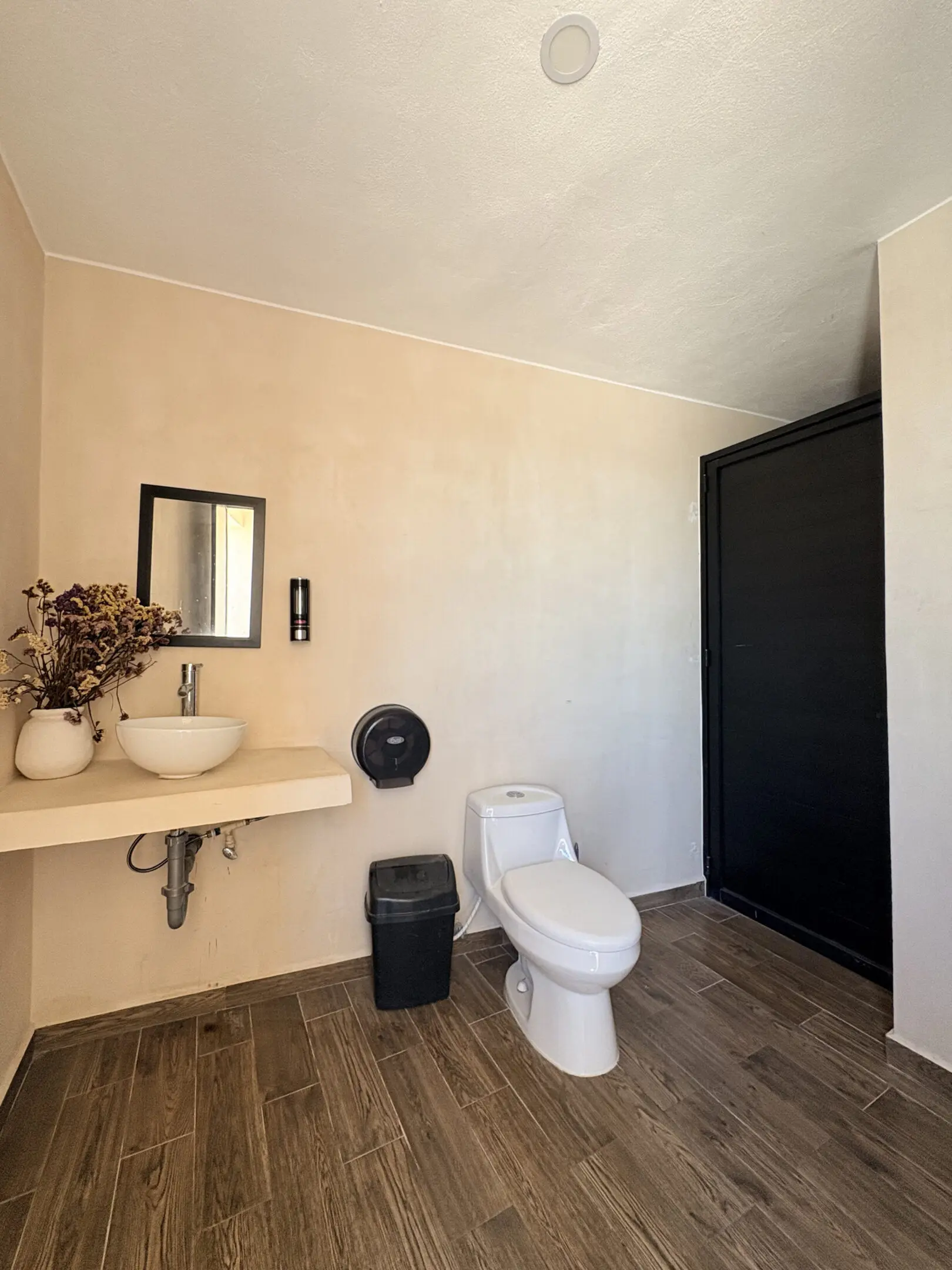 Modern bathroom with sink, toilet, black shower