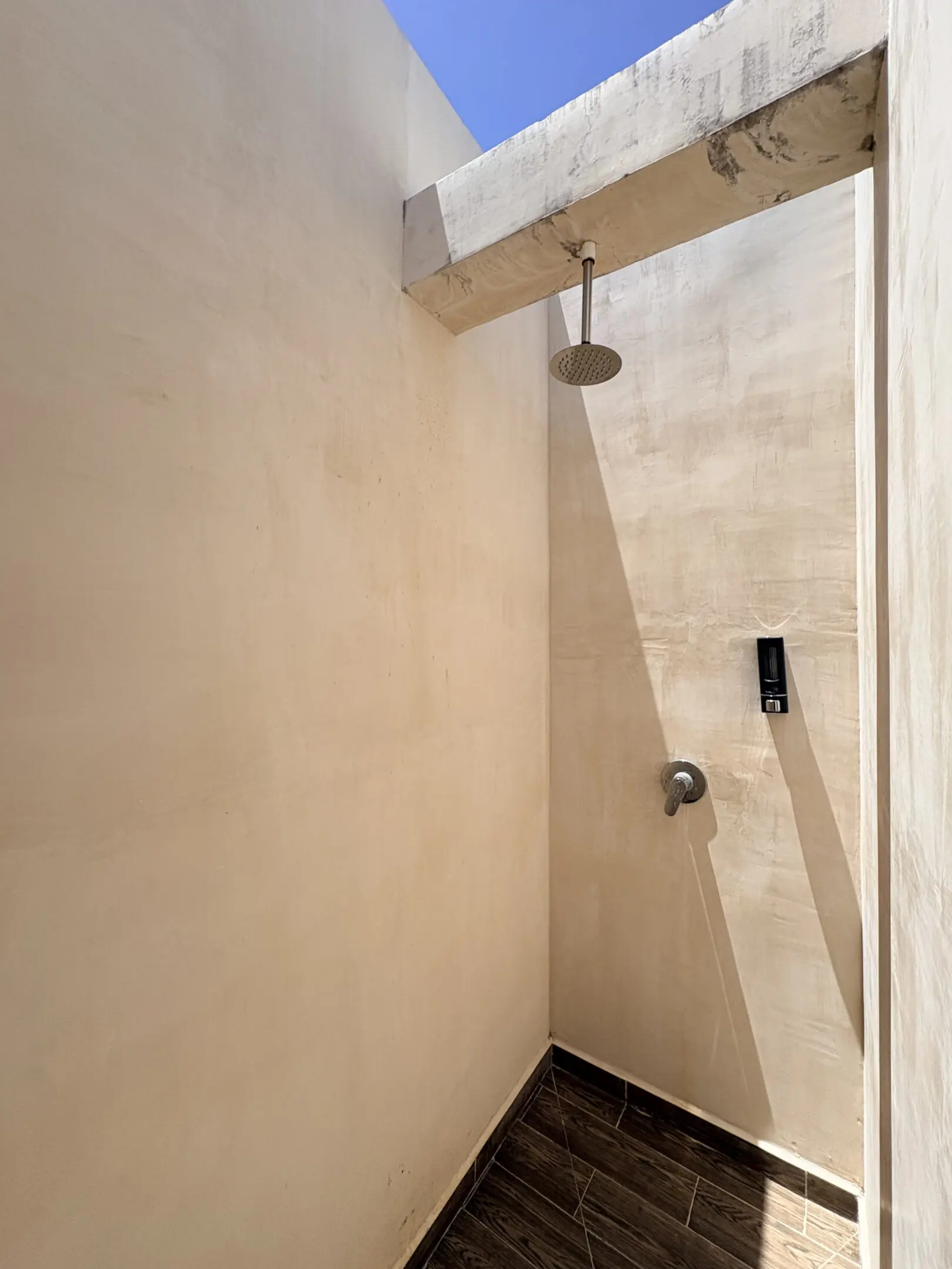Outdoor shower with overhead rain showerhead