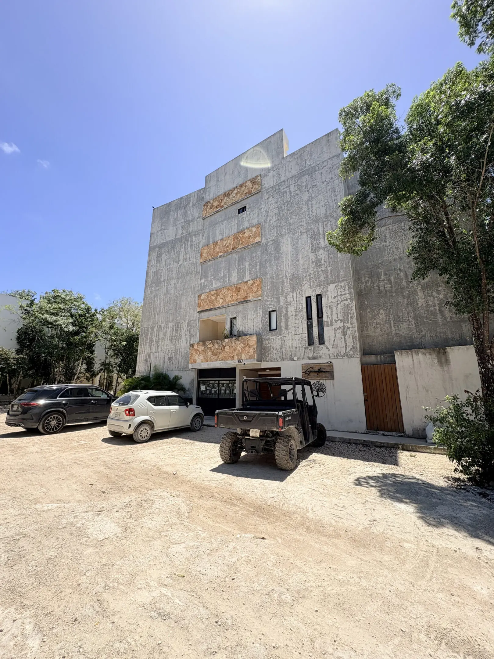 Concrete apartment building with parked vehicles