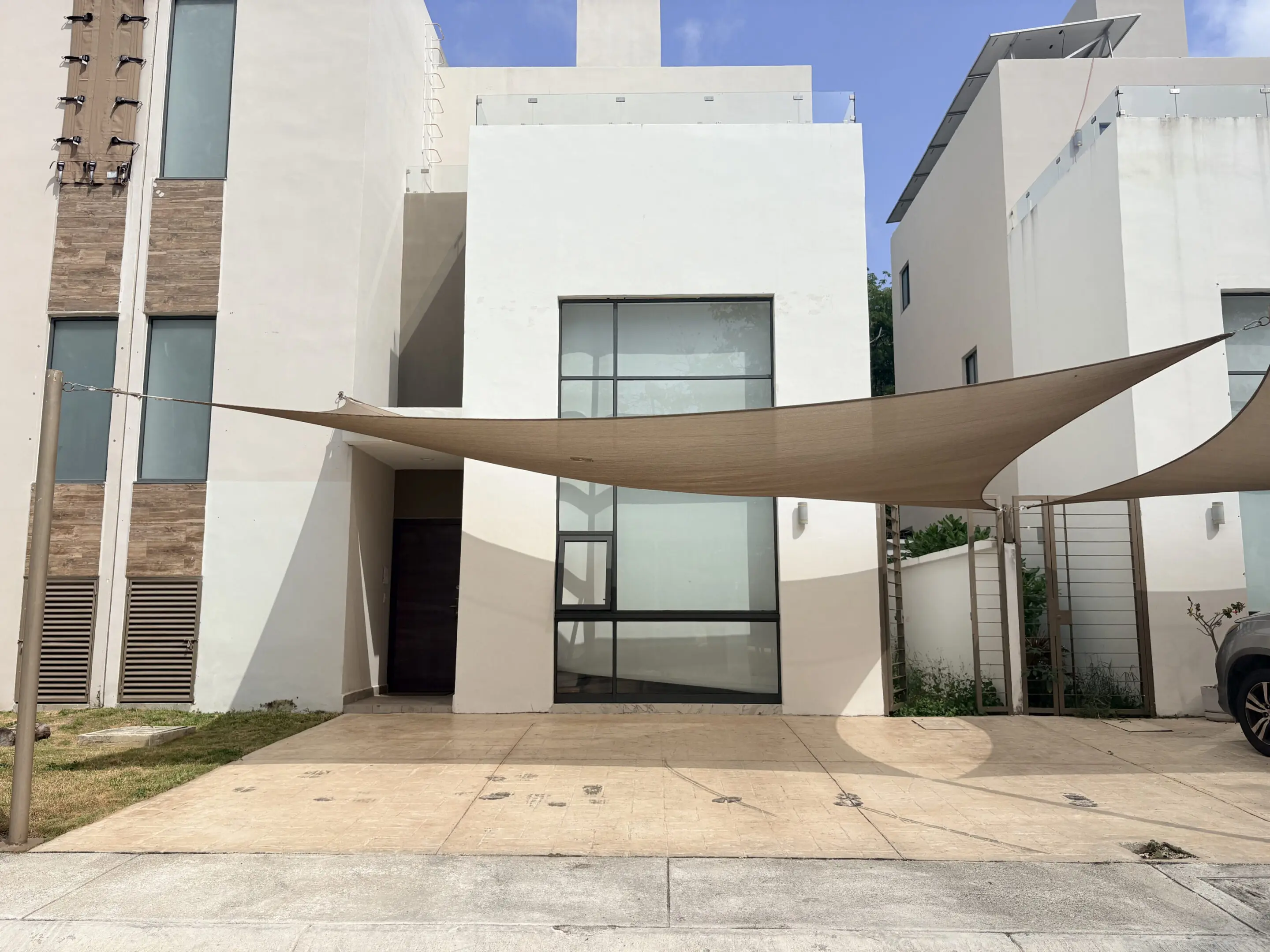 Modern white house with triangular shade sail