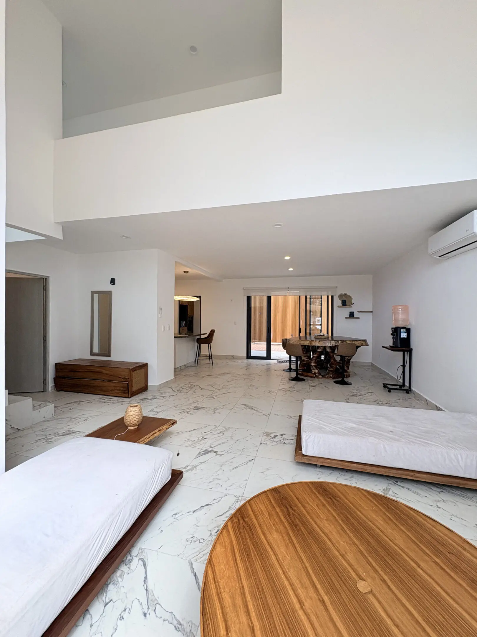 Minimalist open living space with marble floors