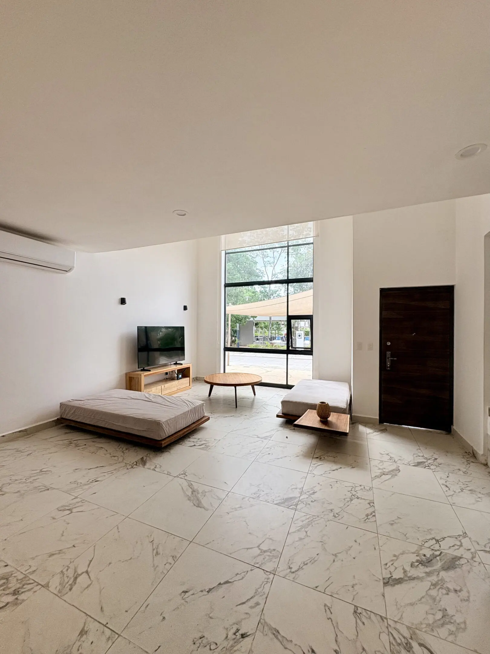 Minimalist living room with marble tile flooring