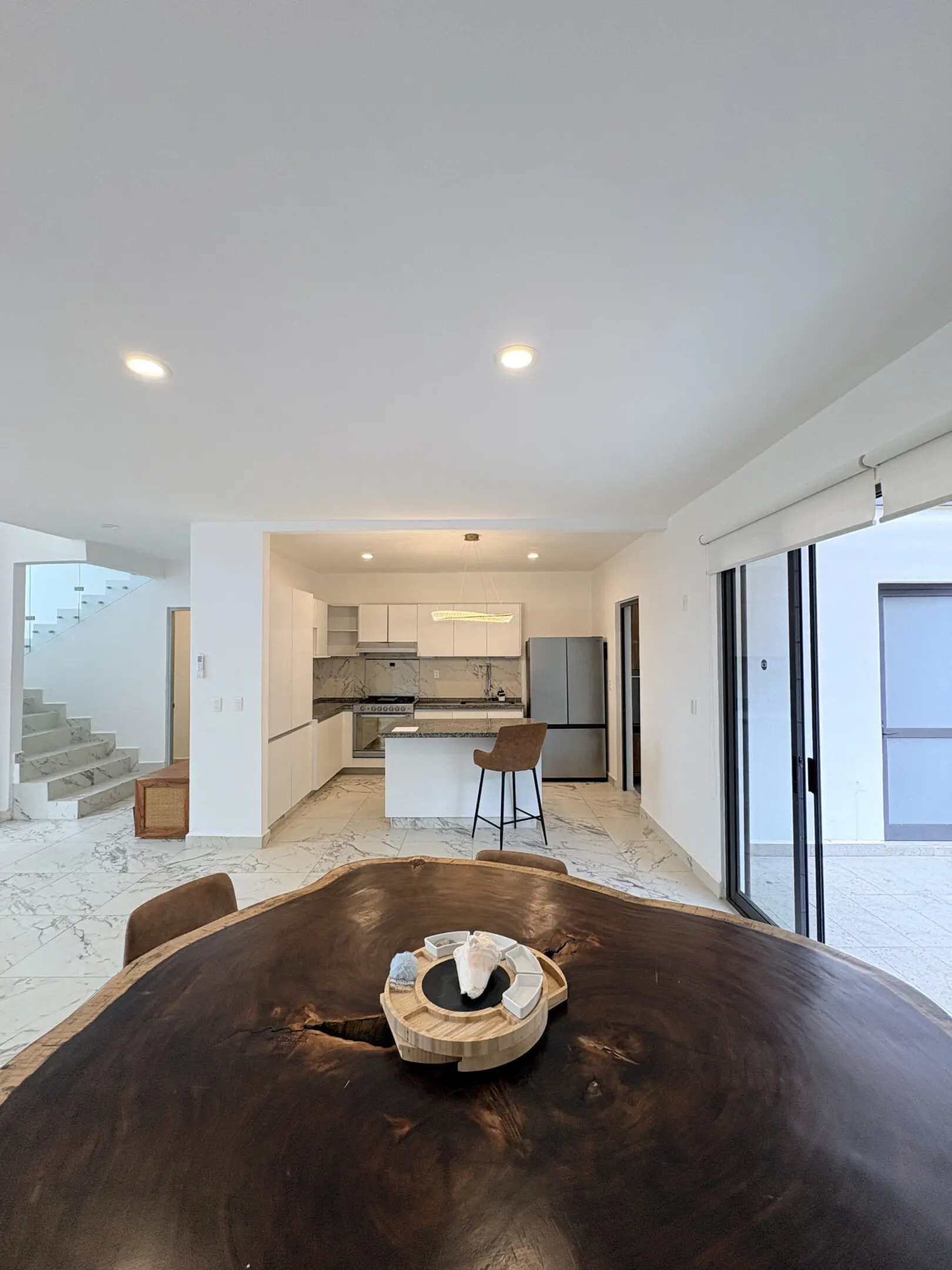 Open-plan kitchen with wooden dining table