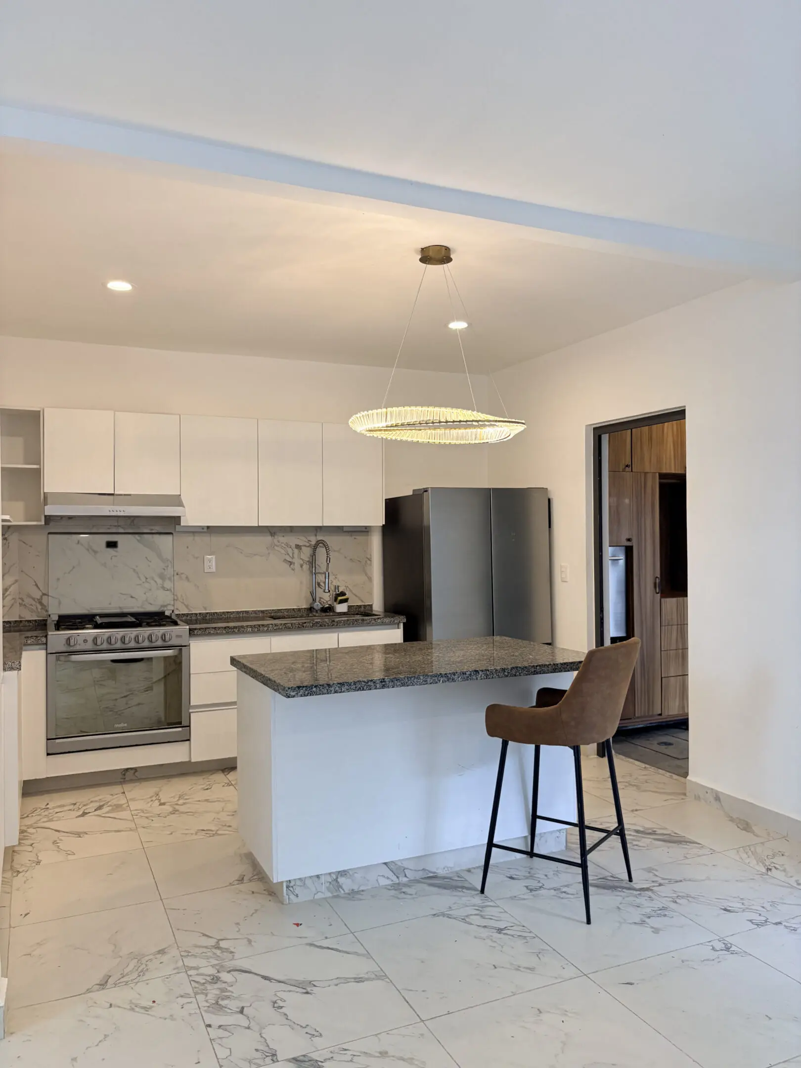 Modern kitchen with island and barstool