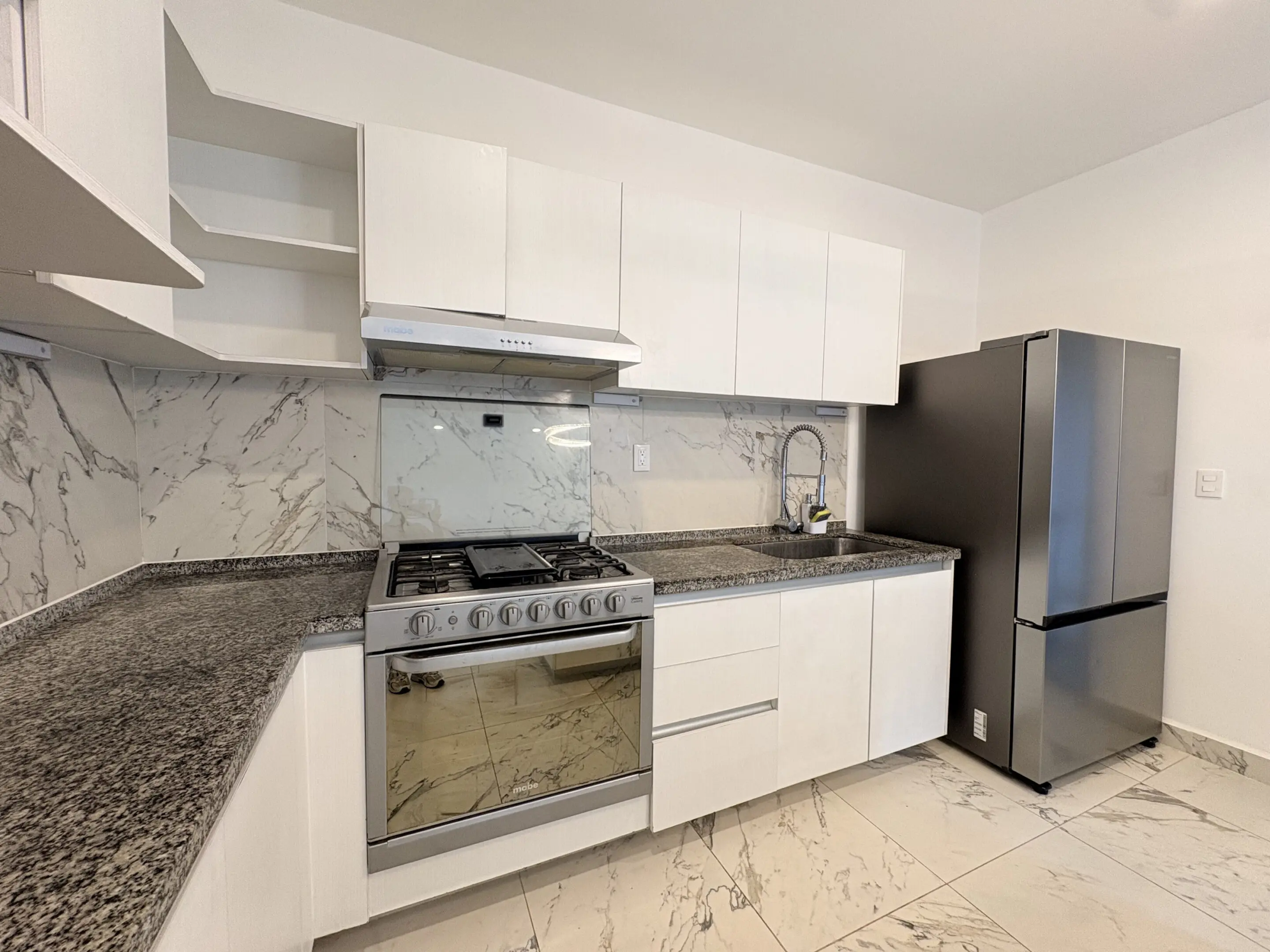 Modern white kitchen with stainless appliances