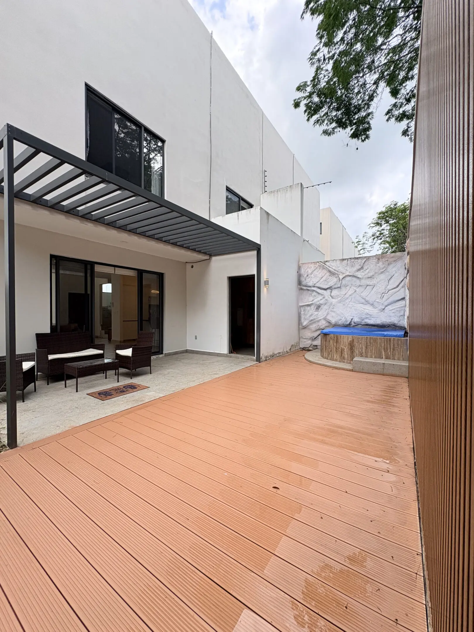Modern patio with wooden deck and pergola
