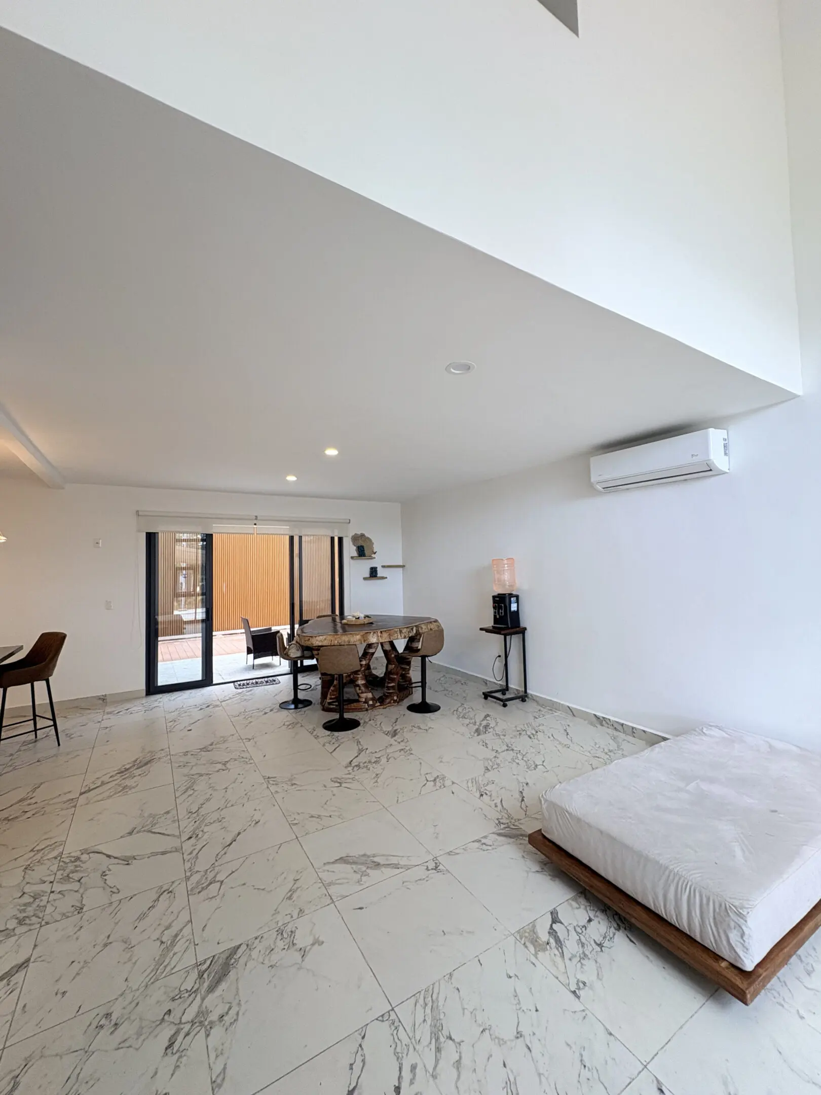 Open minimalist living room with marble floor