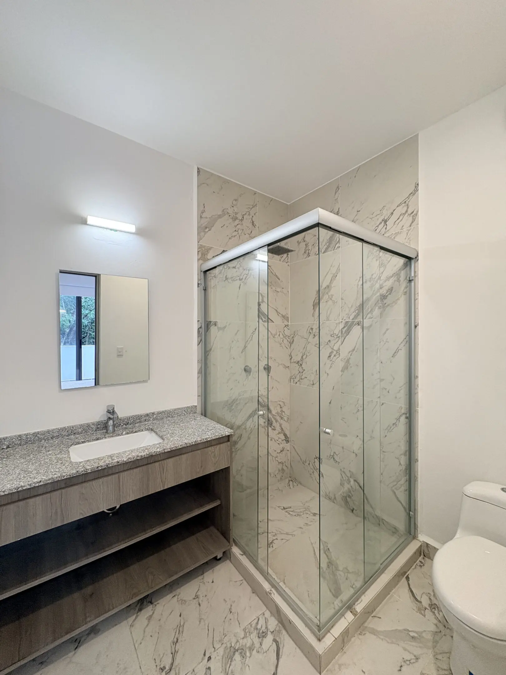 Marble bathroom with glass shower and vanity