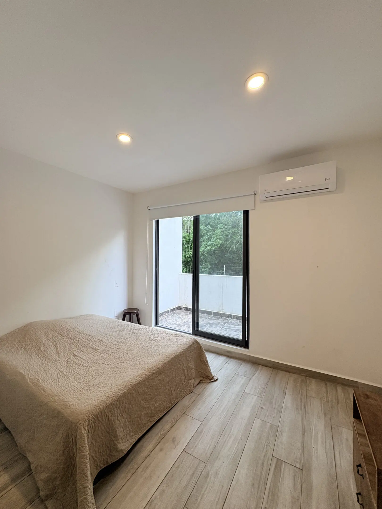 Minimal bedroom with bed, sliding glass door