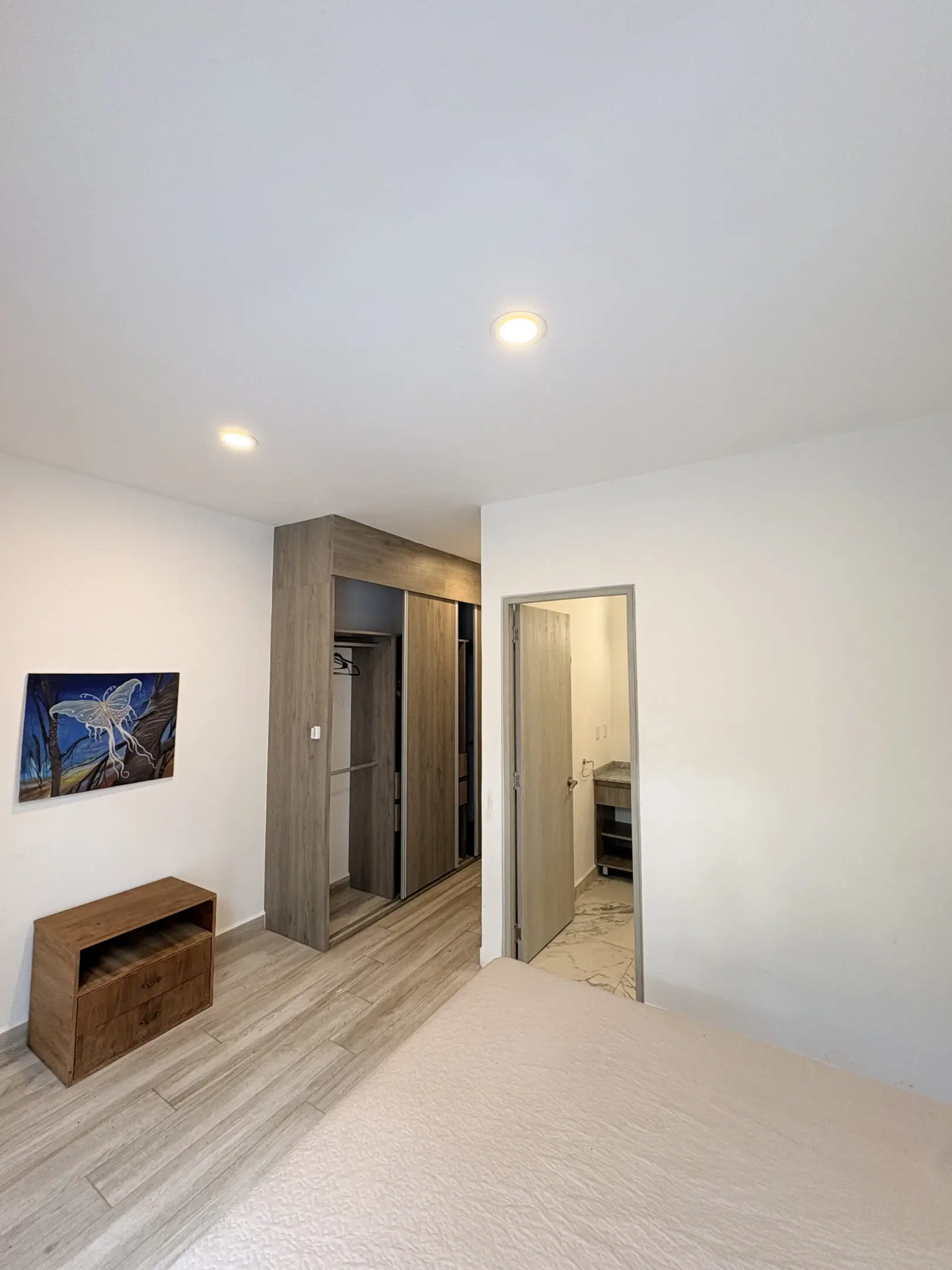 Modern bedroom with wardrobe and en-suite bathroom