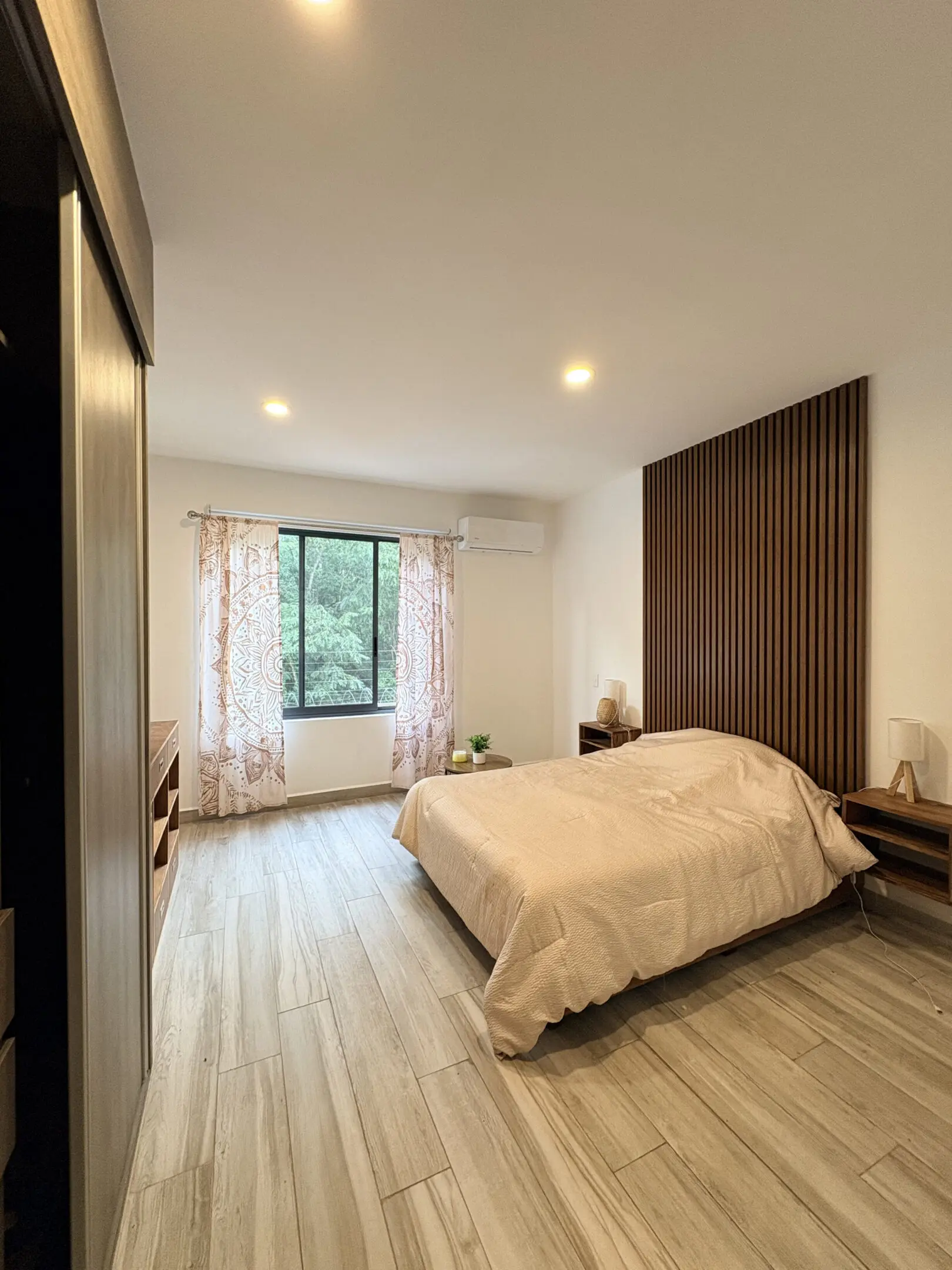Minimalist bedroom with wood slatted accent wall