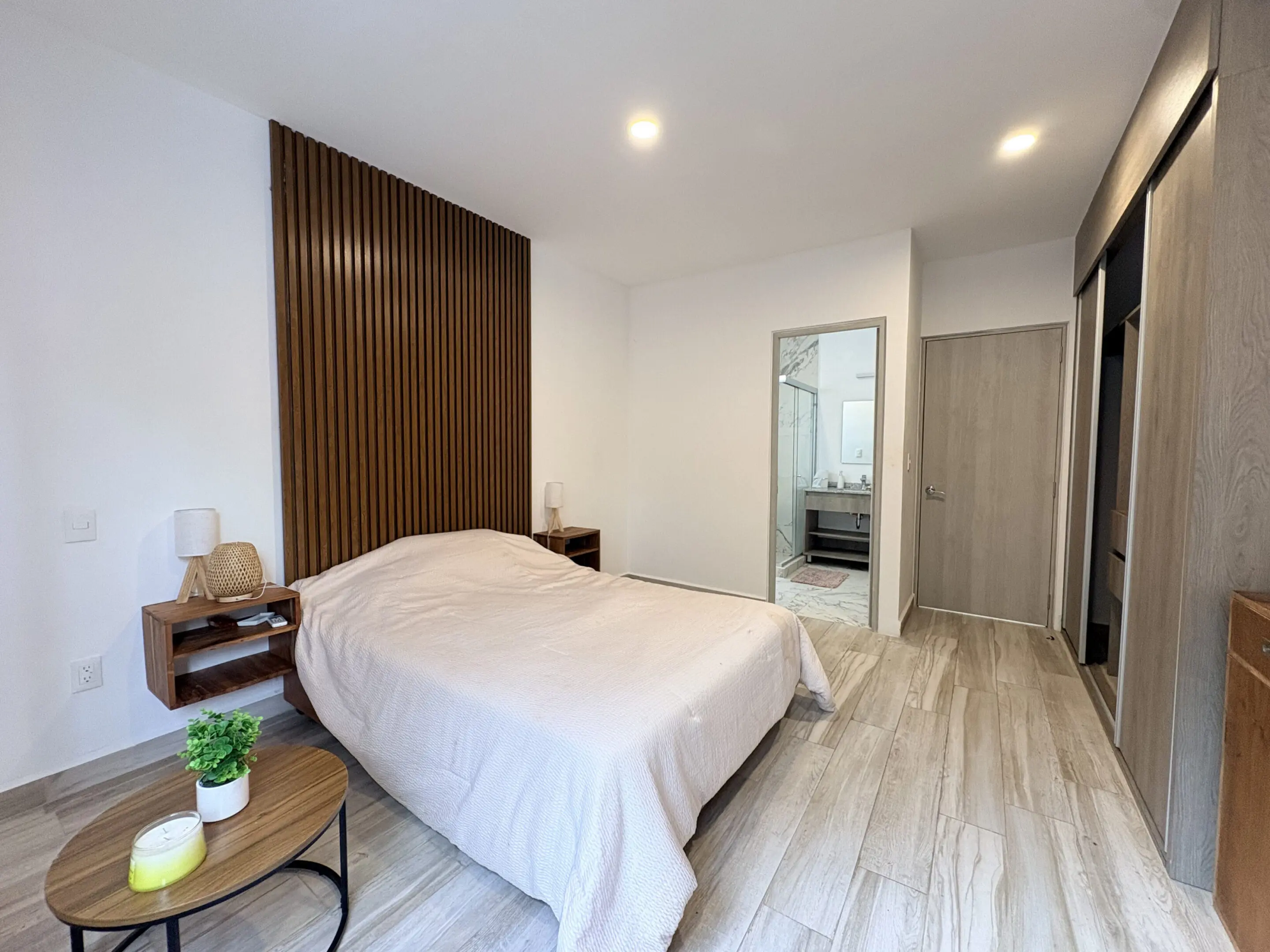 Minimalist bedroom with wood slat accent wall