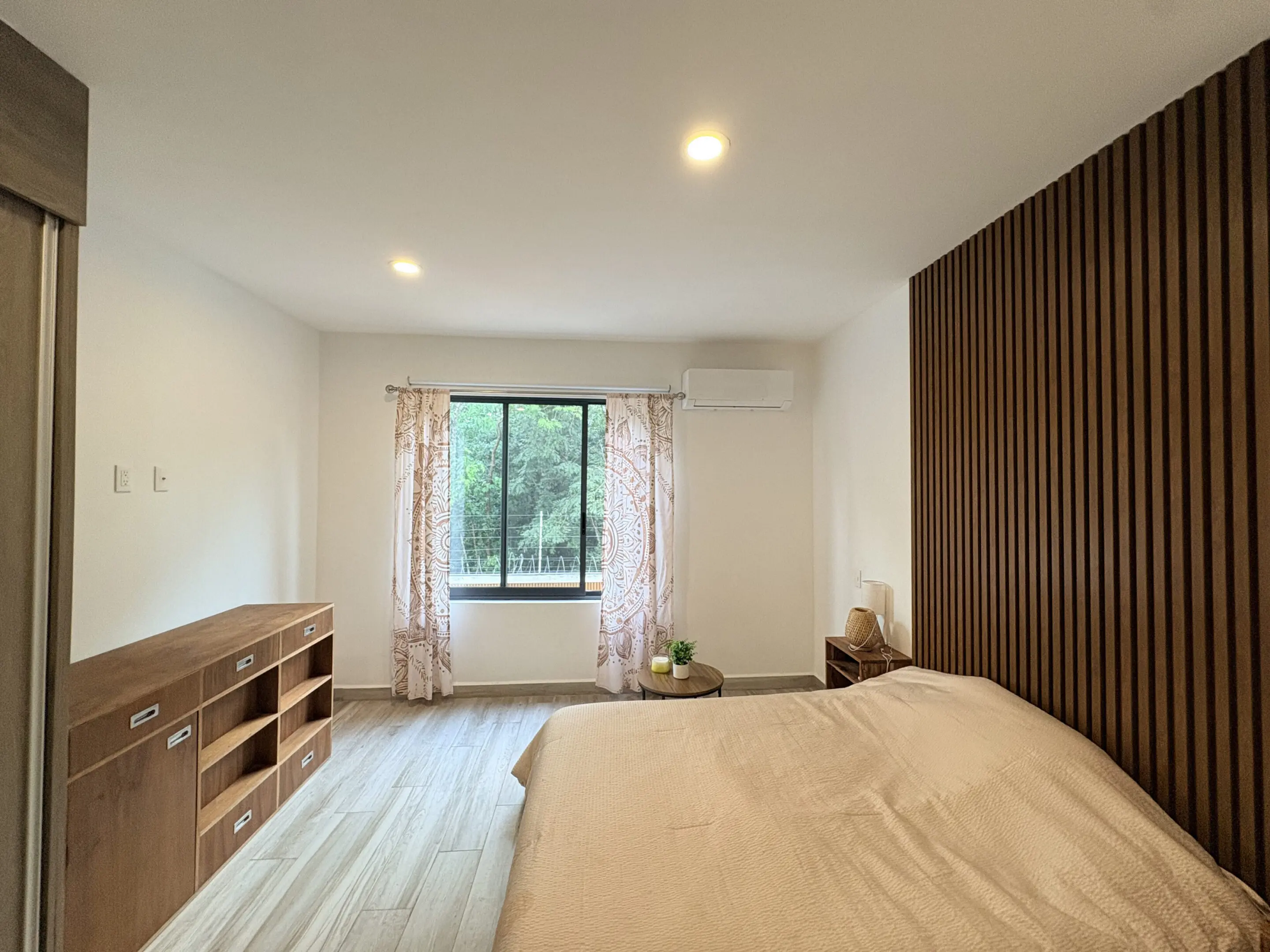 Minimal bedroom with wooden slatted accent wall