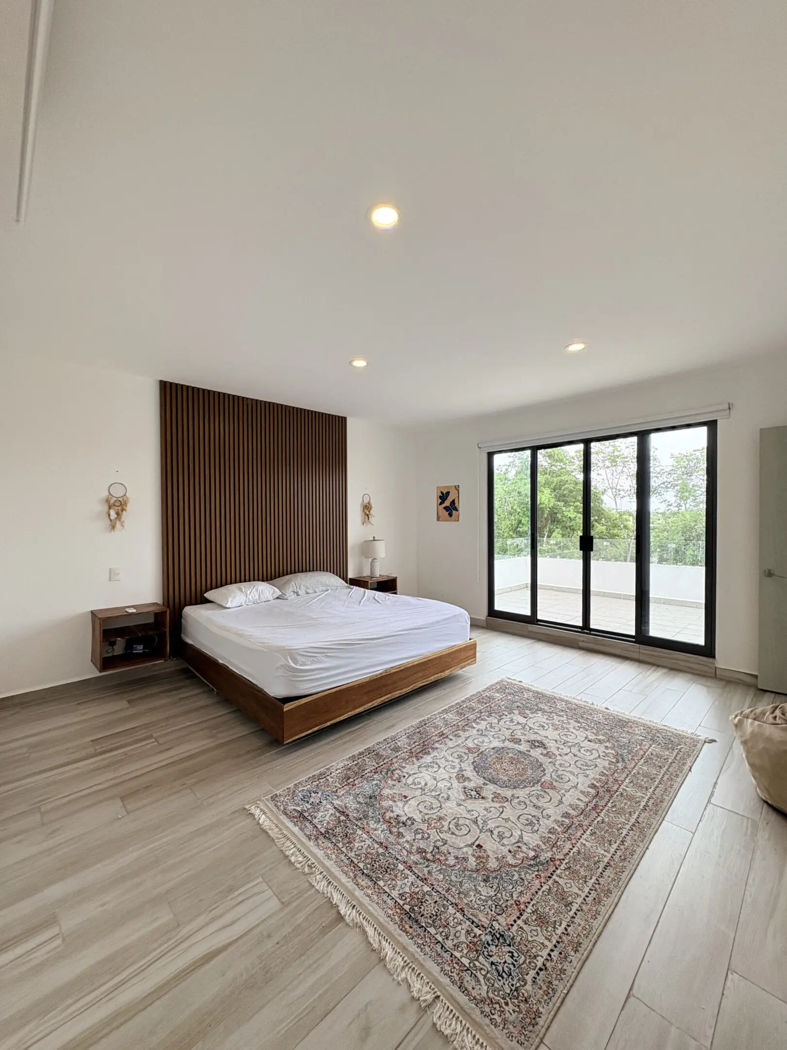 Minimal modern bedroom with sliding glass doors