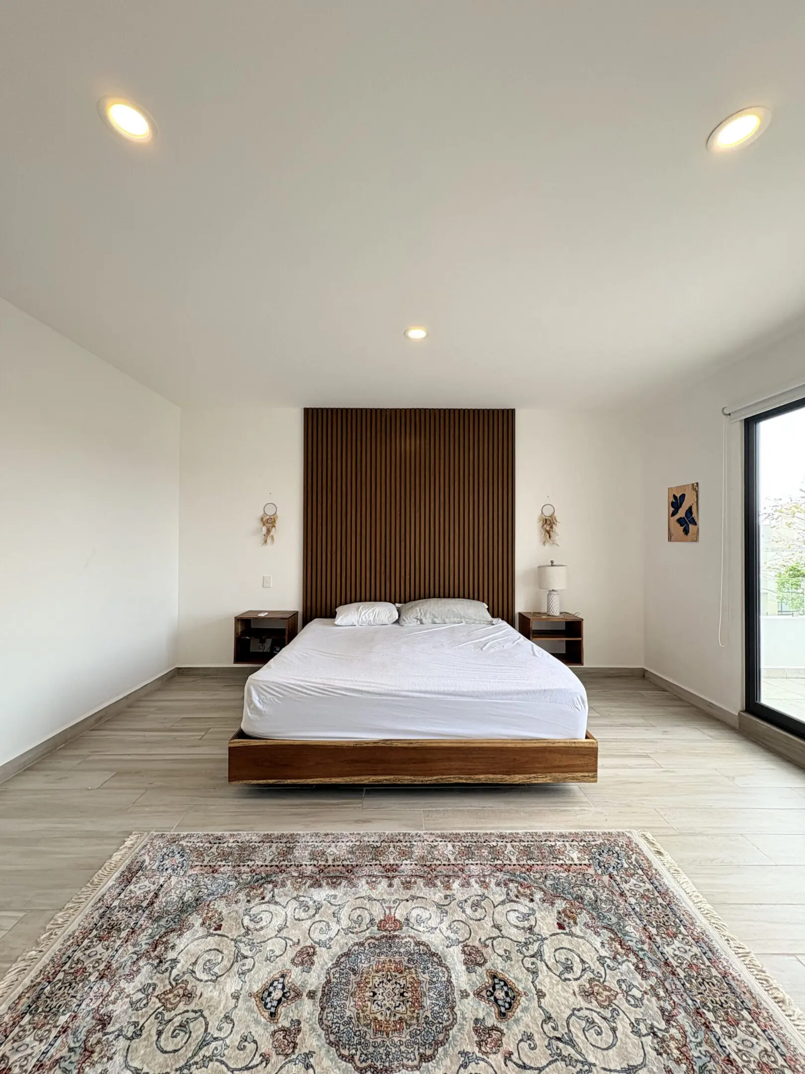 Minimalist bedroom with slatted wooden headboard