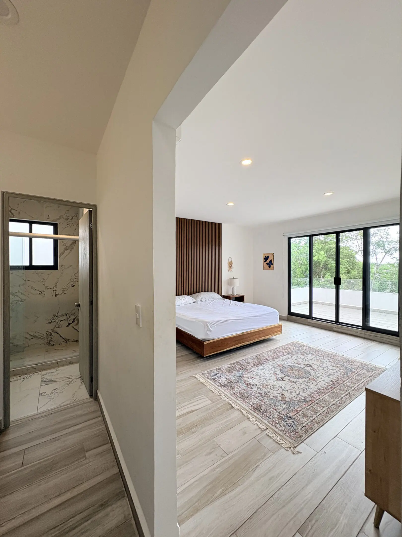 Bright modern bedroom with sliding glass doors