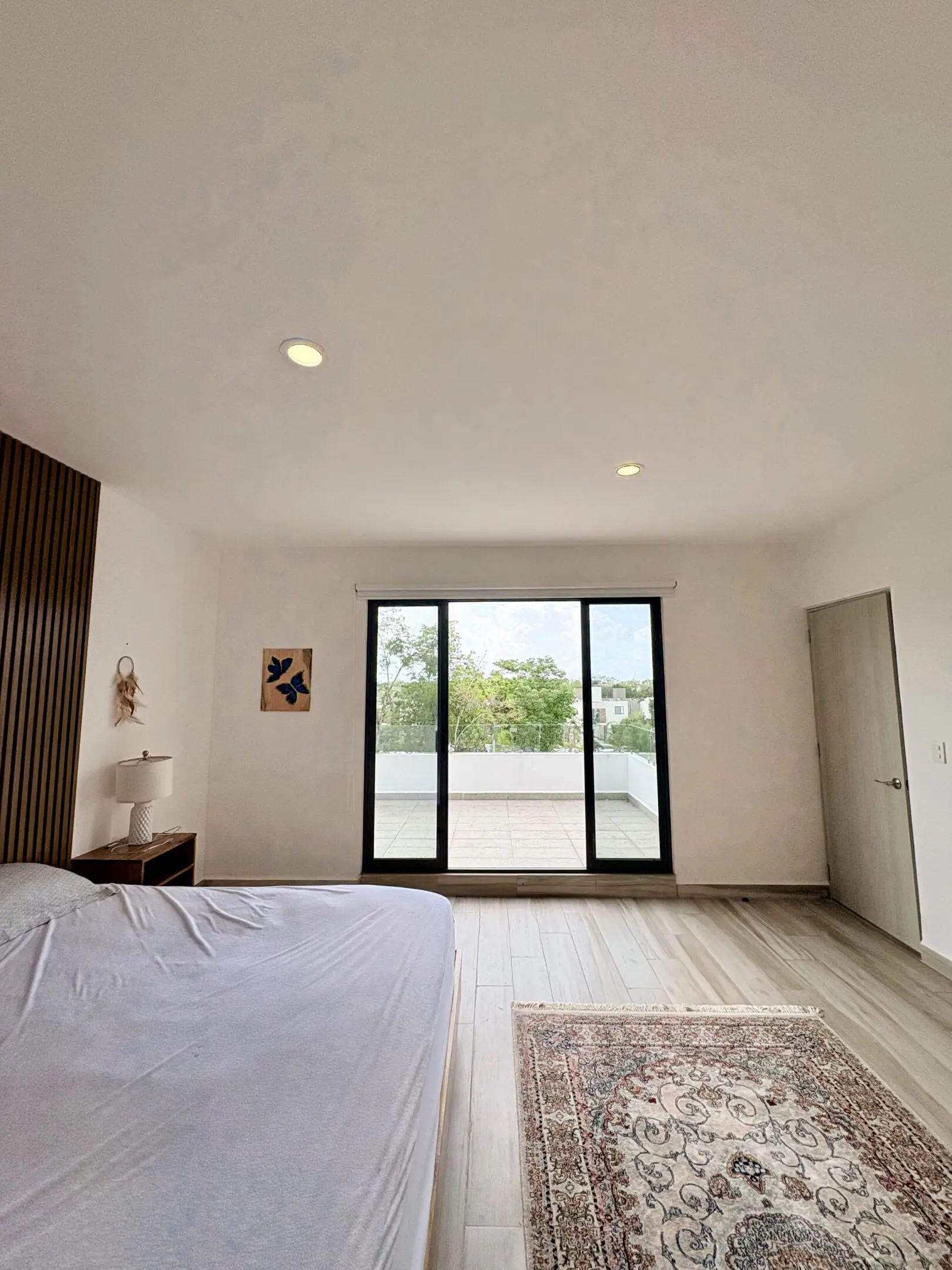 Modern minimalist bedroom with sliding glass doors