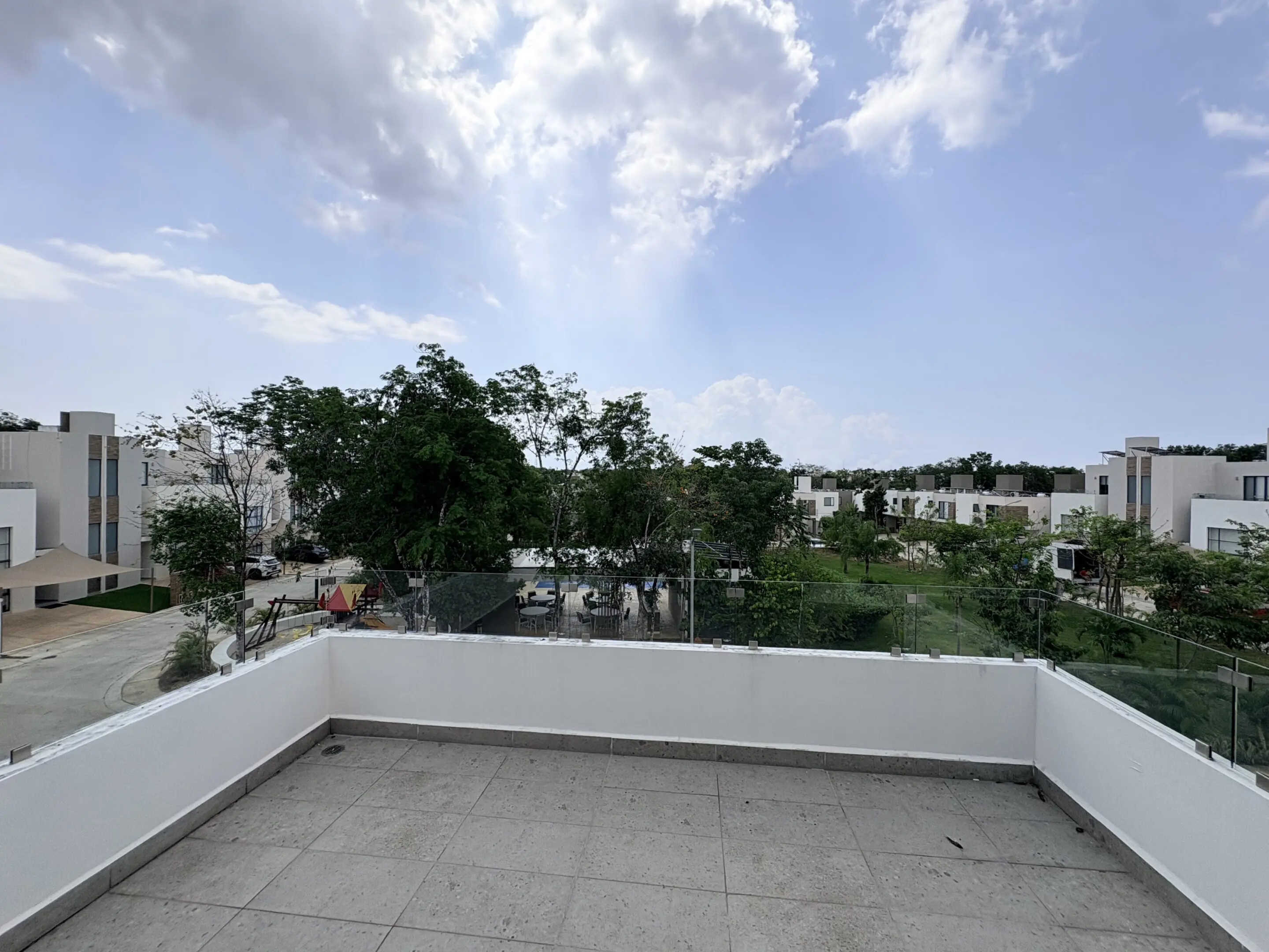 Empty rooftop terrace overlooking suburban neighborhood