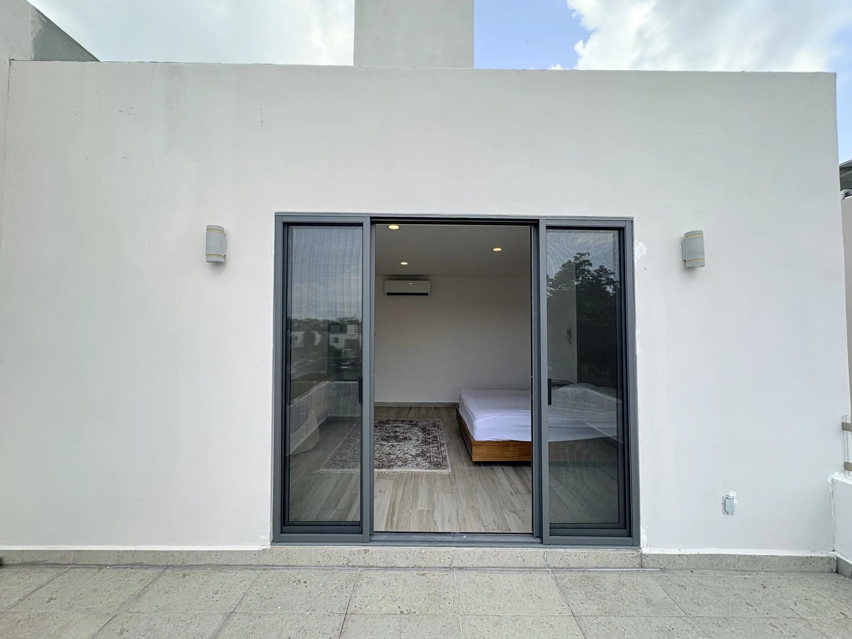 Modern bedroom seen through sliding glass doors