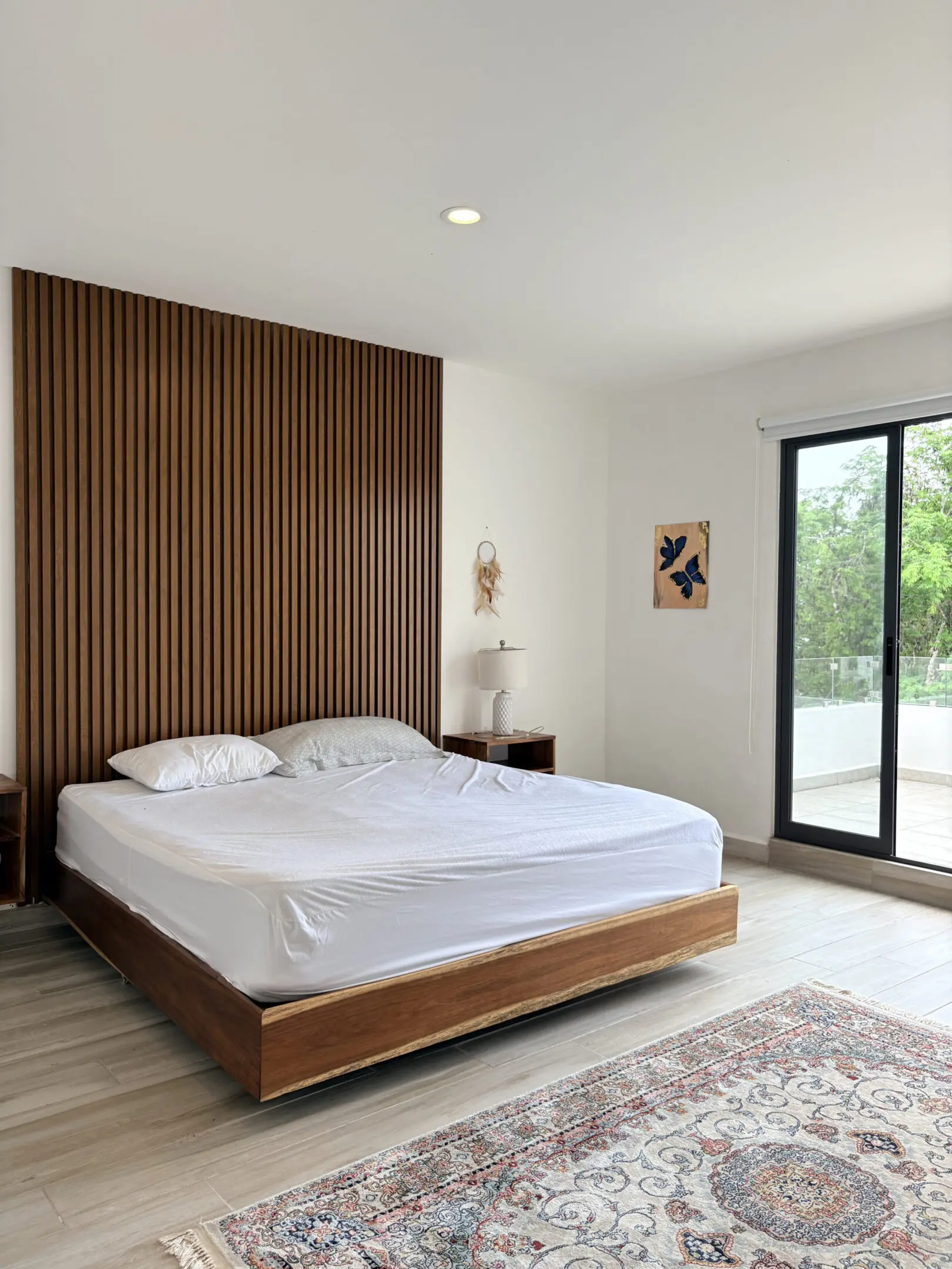 Minimalist bedroom with wooden slatted wall