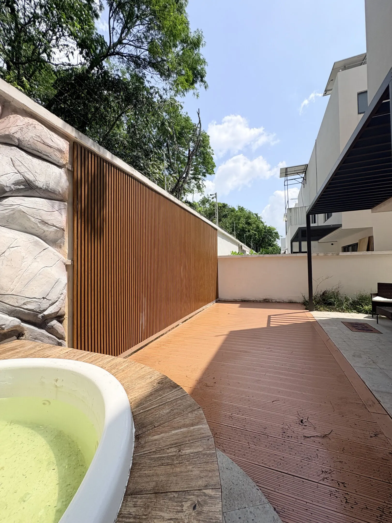 Backyard patio with wooden slat fence