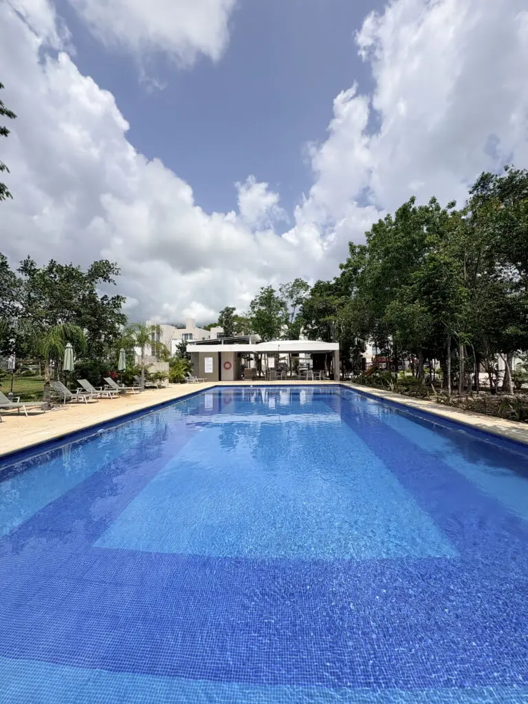 Outdoor rectangular swimming pool with lounge chairs