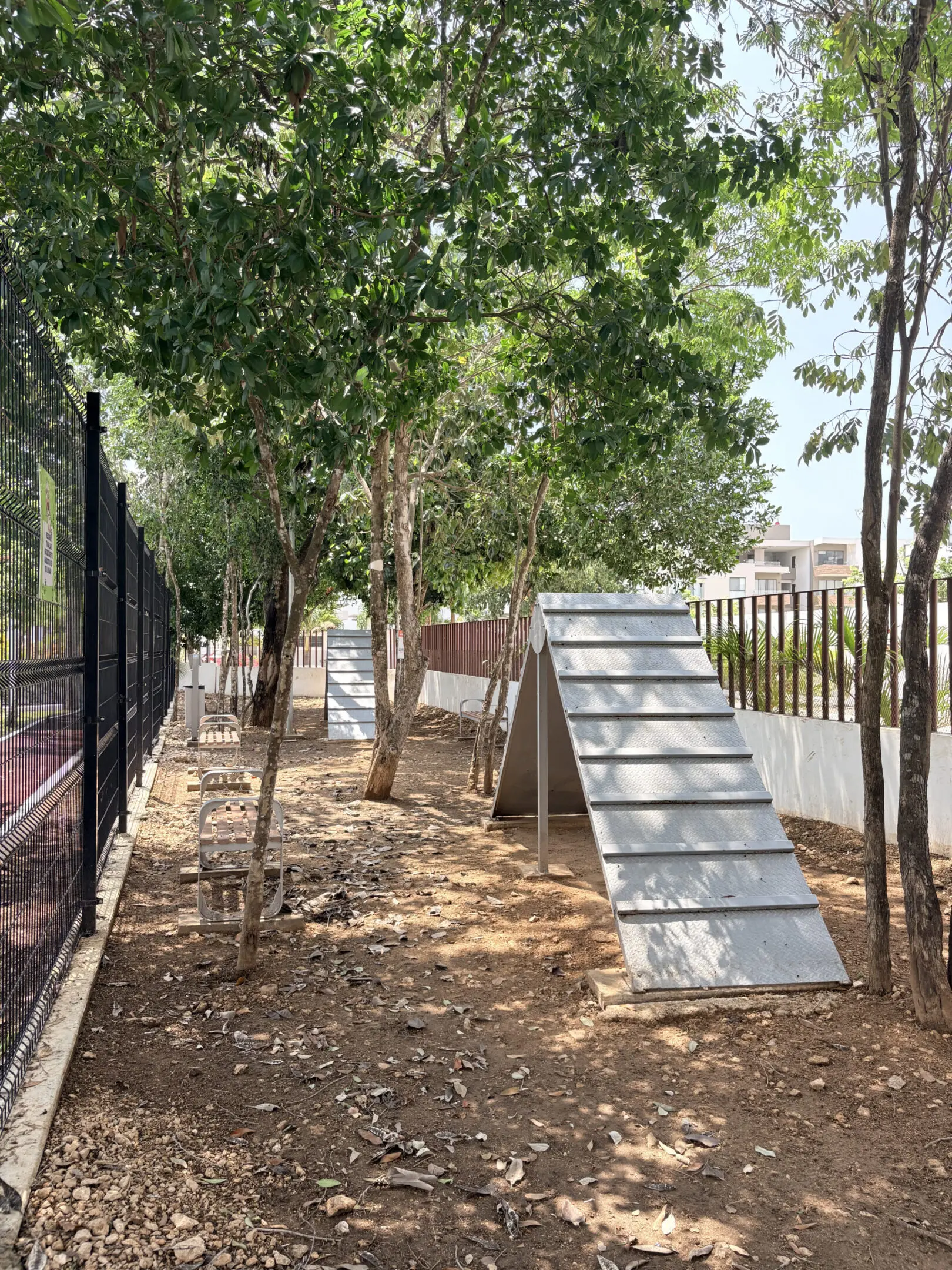 Fenced dog agility course with A-frames