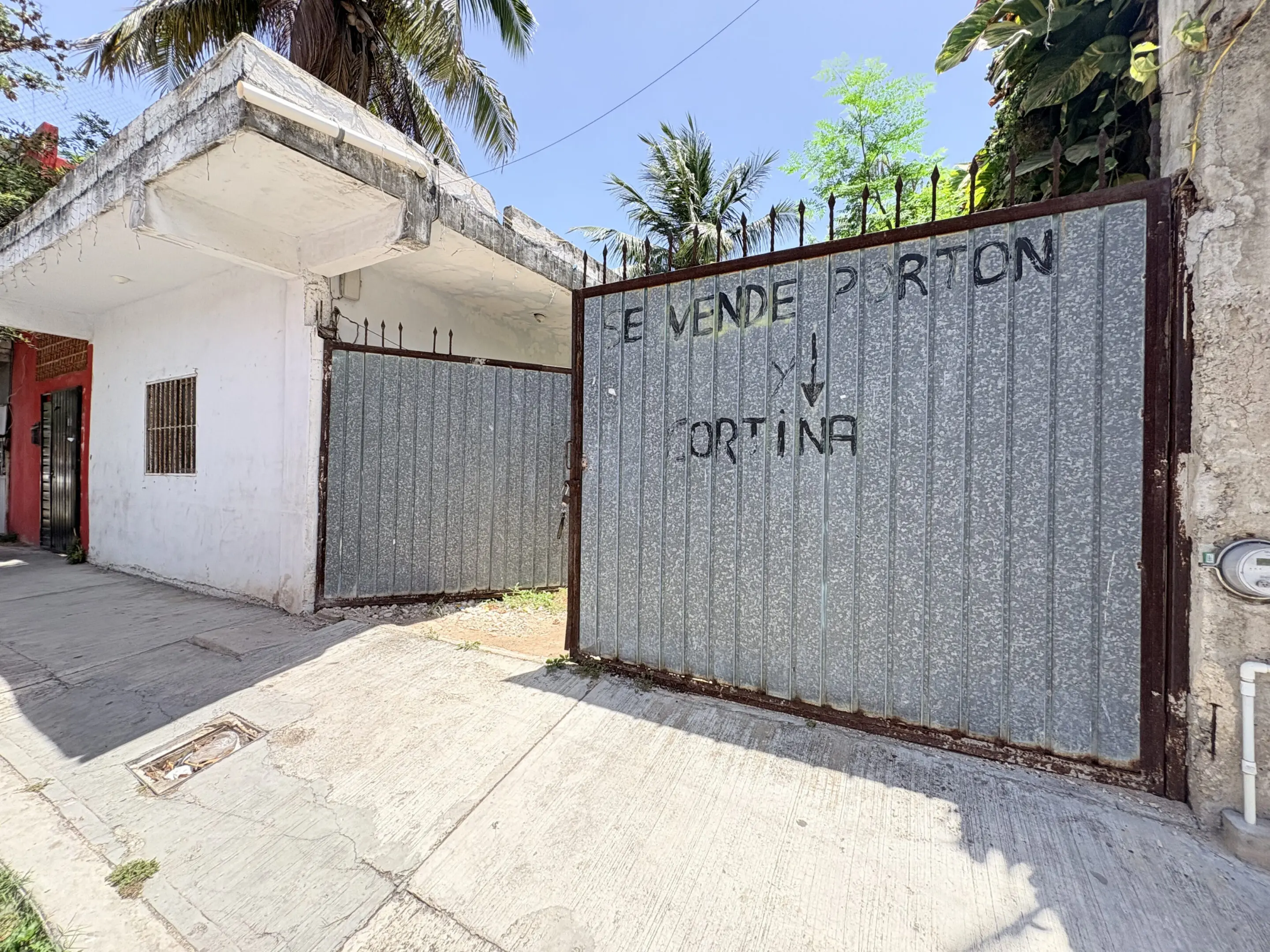 Corrugated metal gate with handwritten for-sale sign