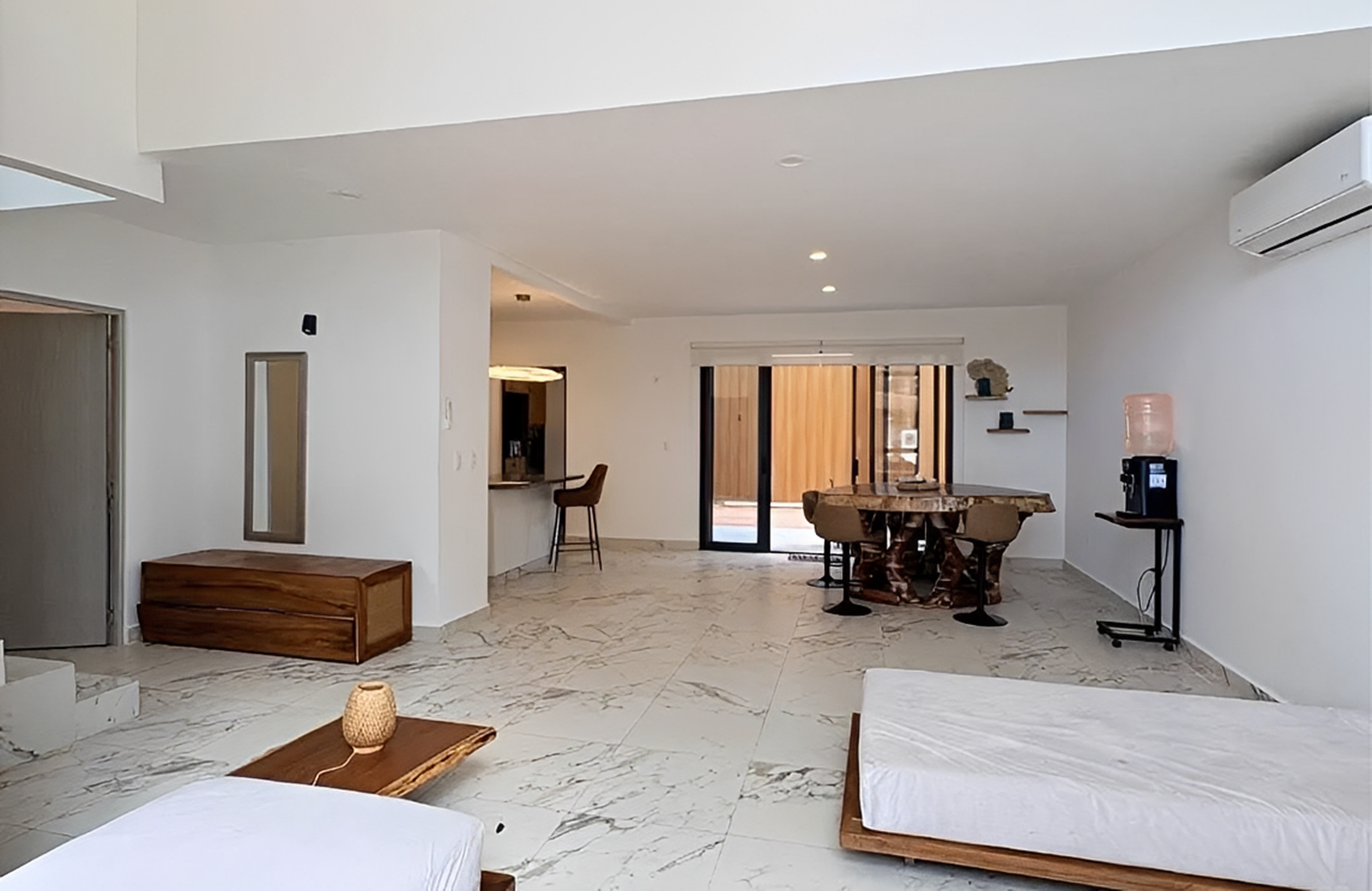 Modern minimalist living room with marble flooring.