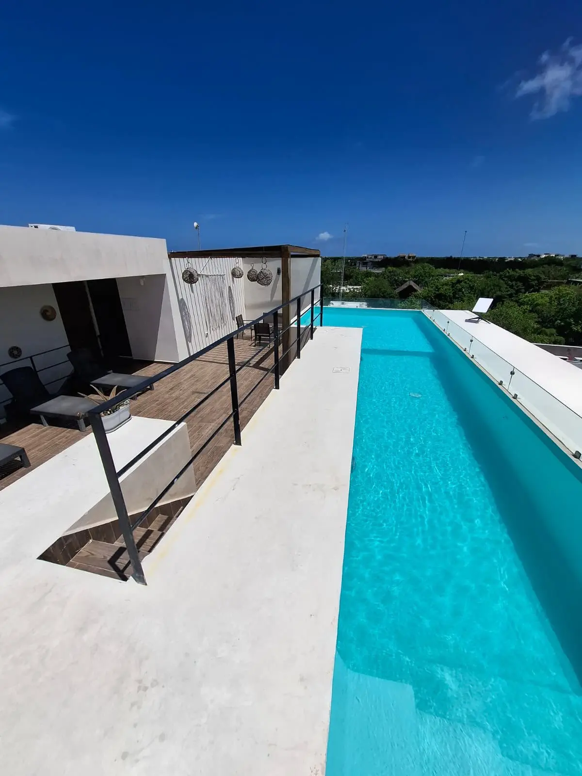Rooftop infinity pool with terrace seating
