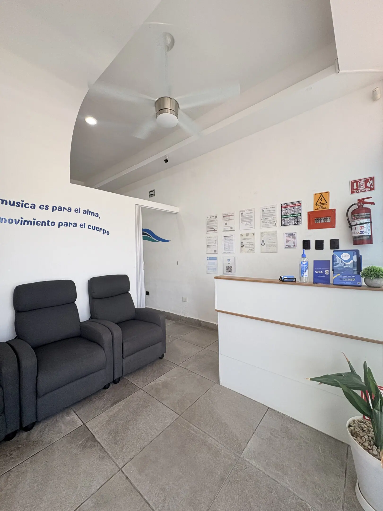 Small clinic waiting room with reception desk