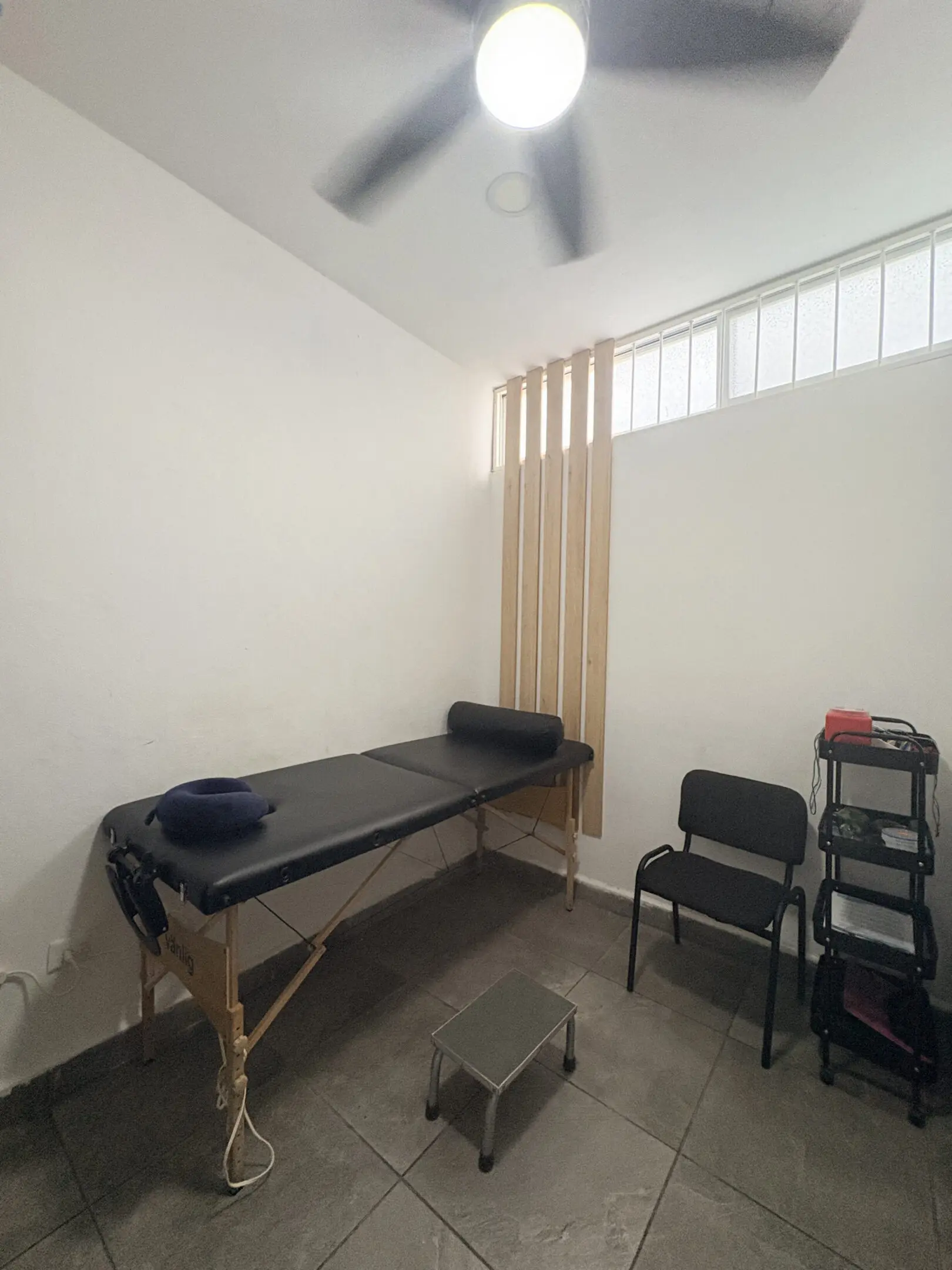 Small massage therapy room with treatment table
