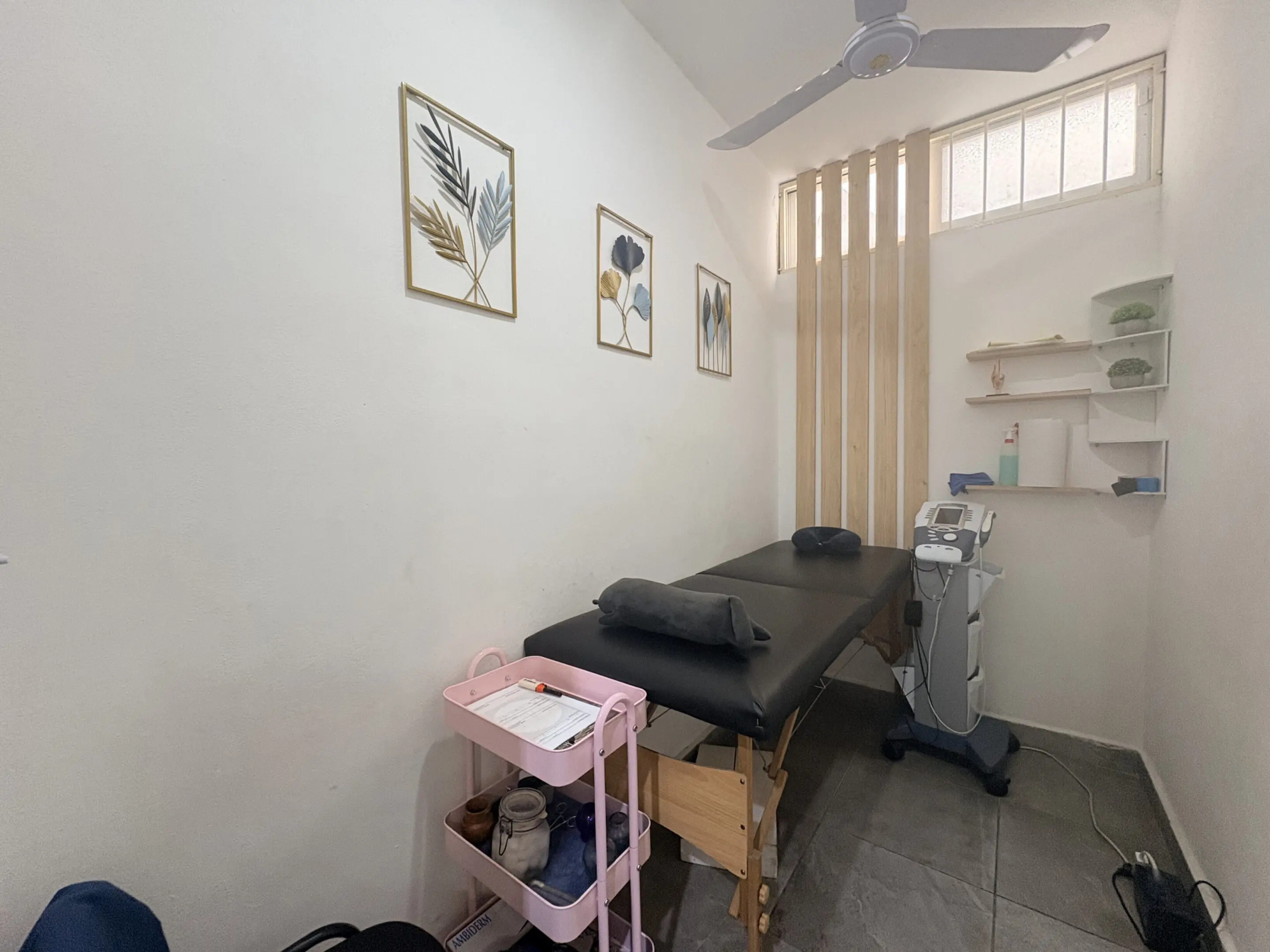 Minimalist spa treatment room with massage table