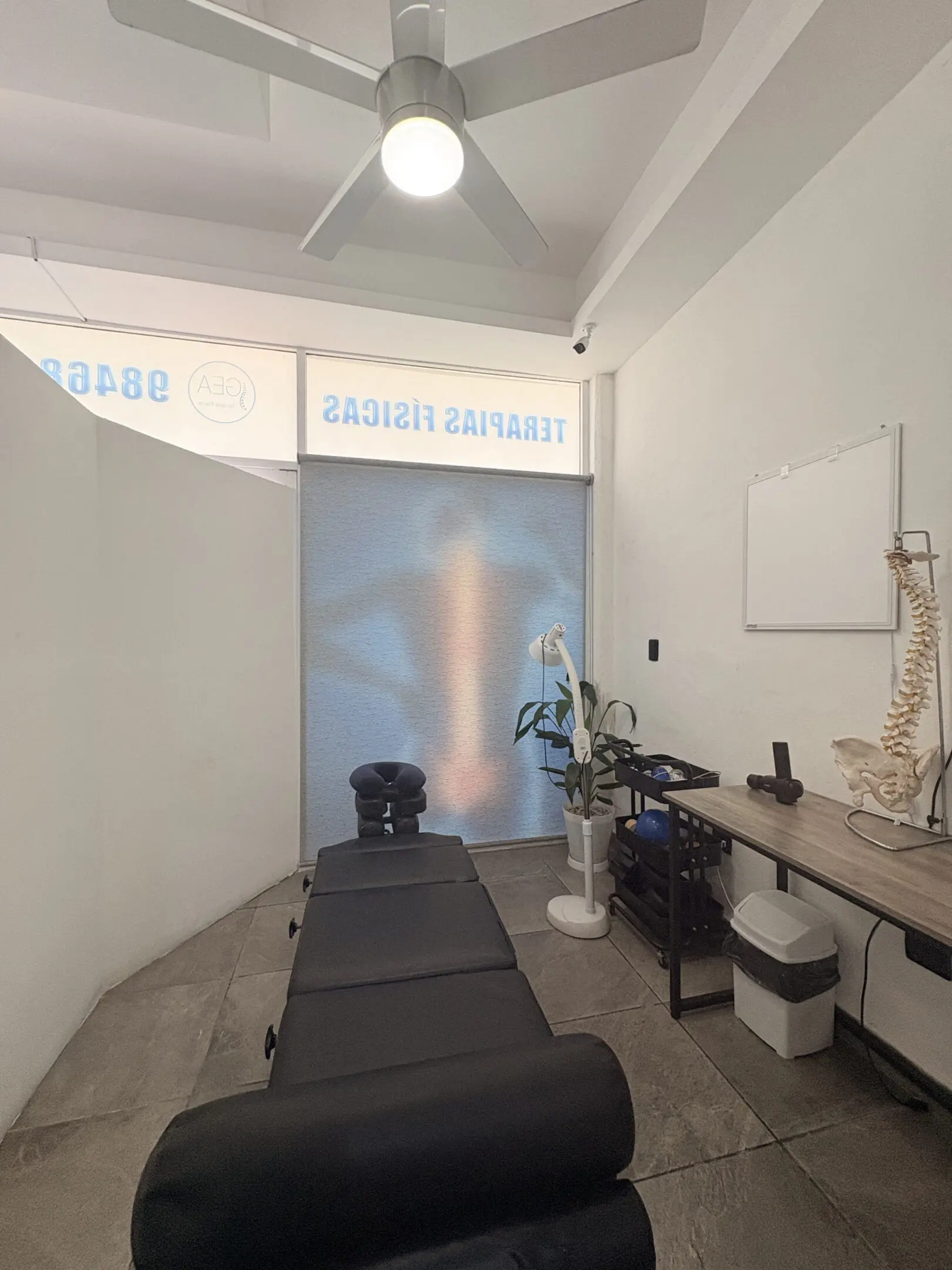 Chiropractic room with adjustment table and spine model