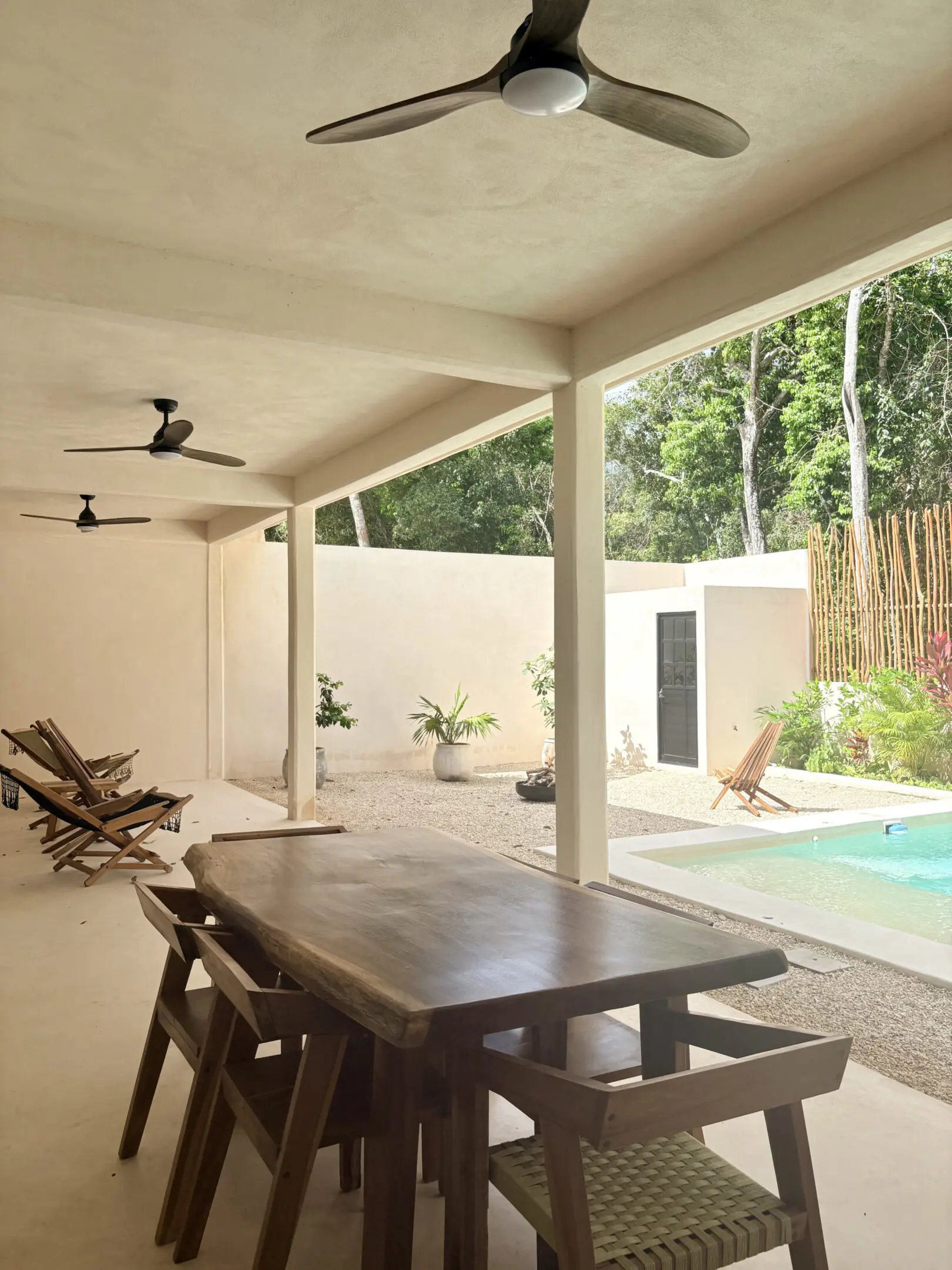Covered patio with dining table and pool