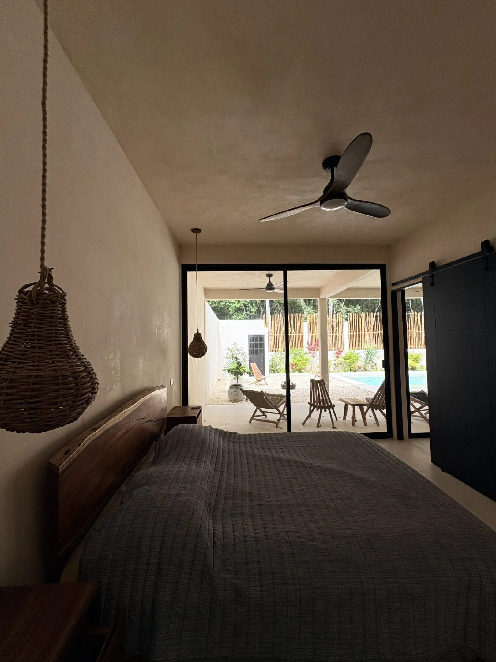 Cozy bedroom with sliding doors to pool