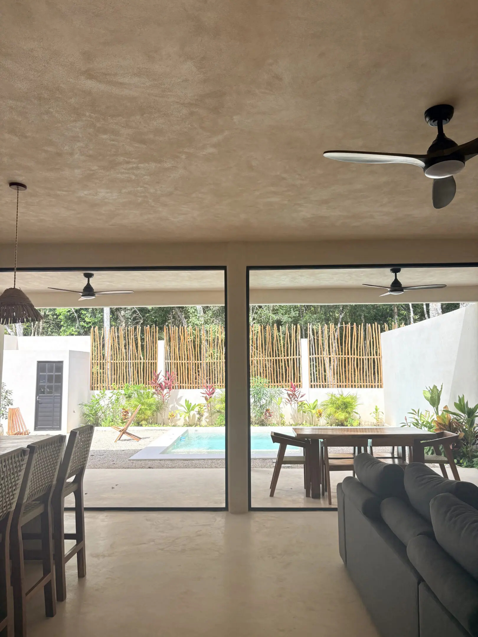 Living room opening to patio and pool