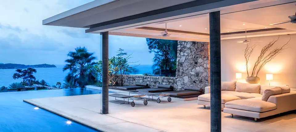 Luxury poolside patio with ocean view.