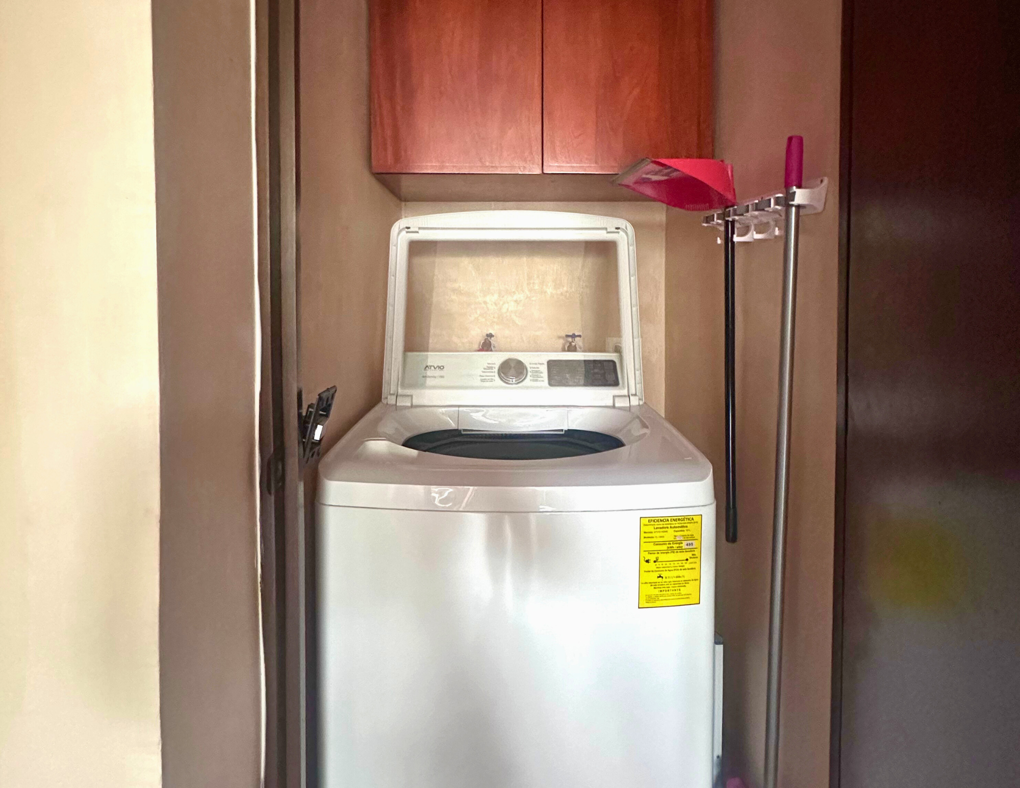Top-loading washing machine in small laundry closet
