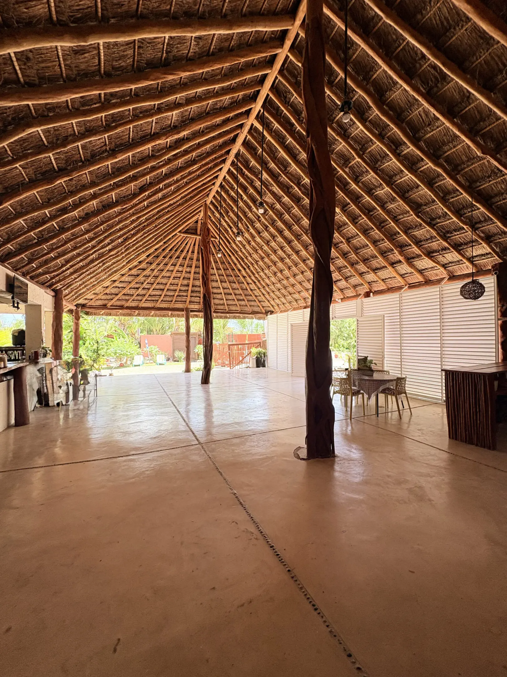 Spacious thatched-roof pavilion with wooden columns