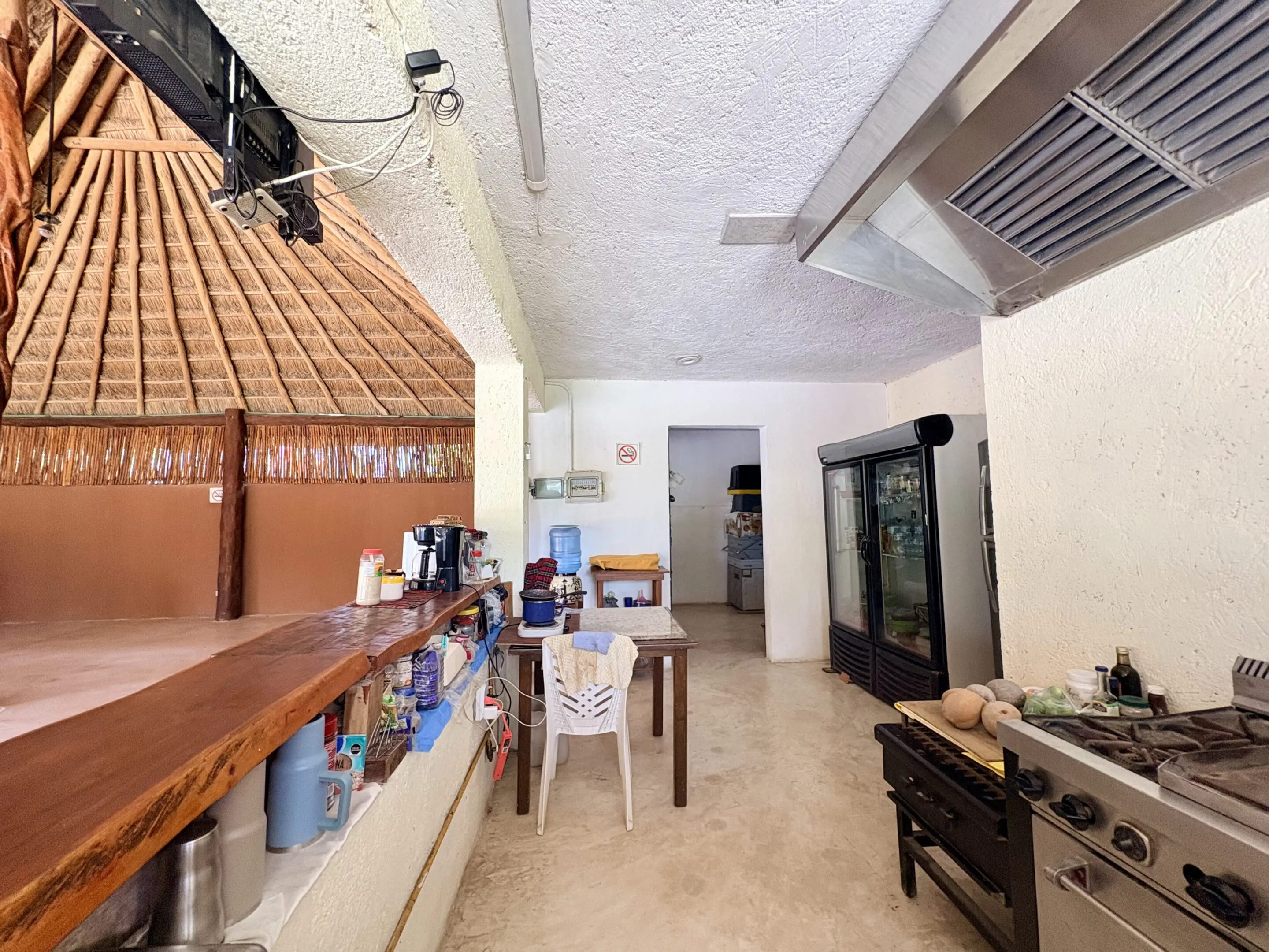 Open air kitchen with wooden bar and stove