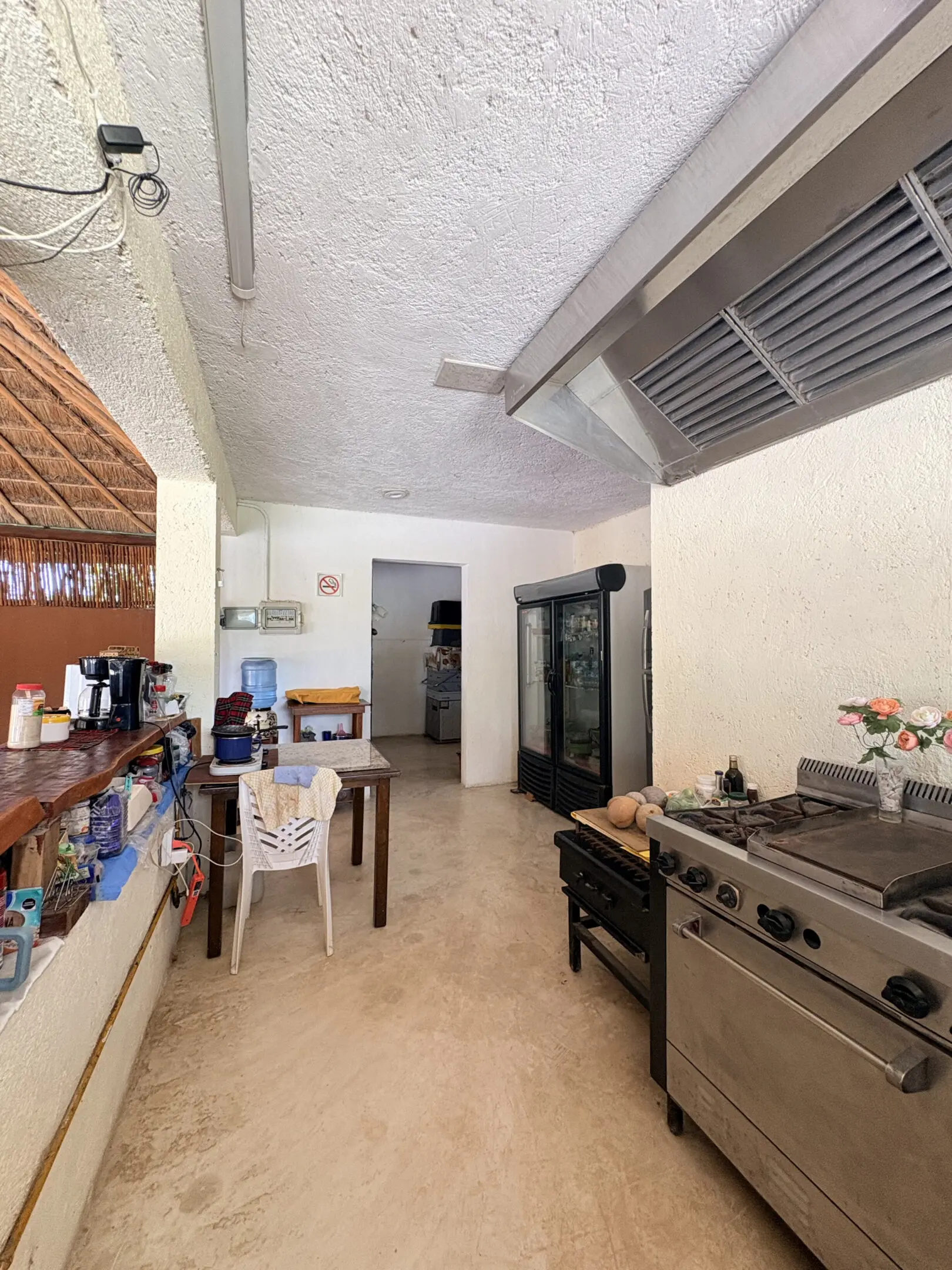Covered outdoor kitchen with stove and fridge