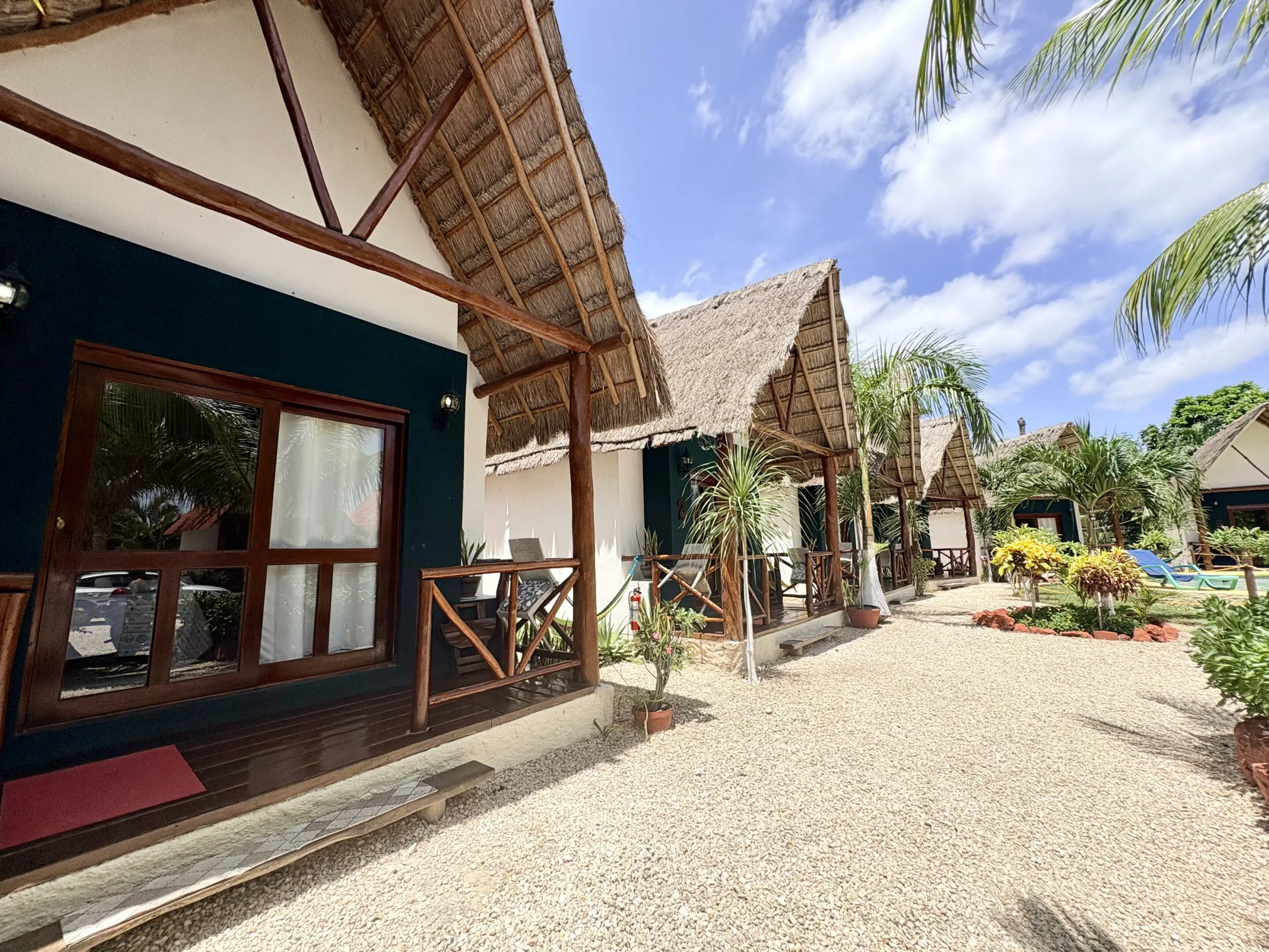 Thatched roof beach bungalows along sunny pathway