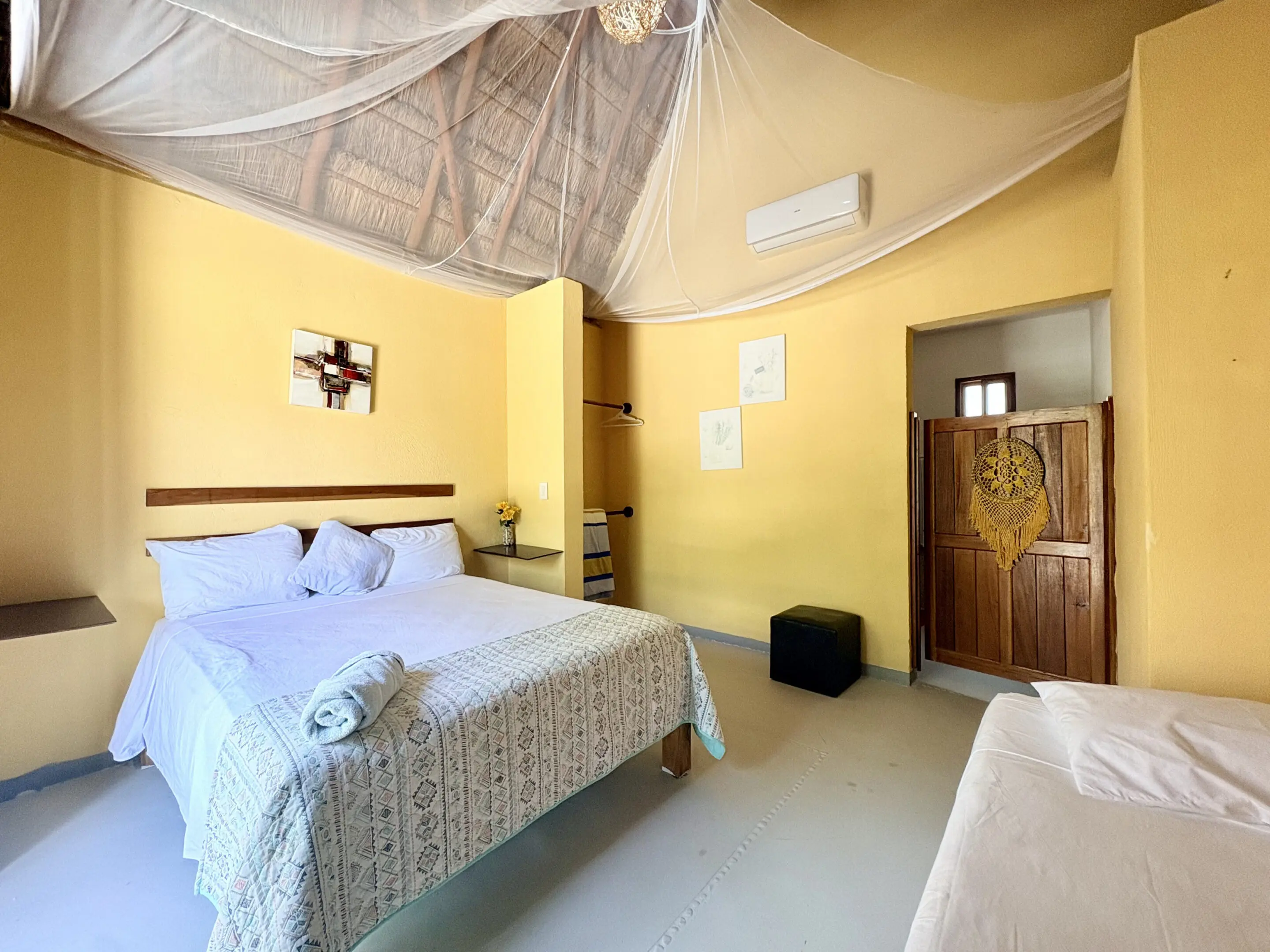 Yellow bedroom with bed and mosquito net